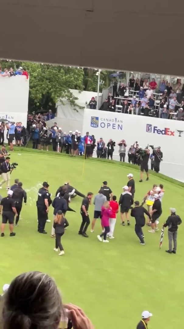 Adam Hadwin gets speared by security trying to celebrate with his friend Nick Taylor