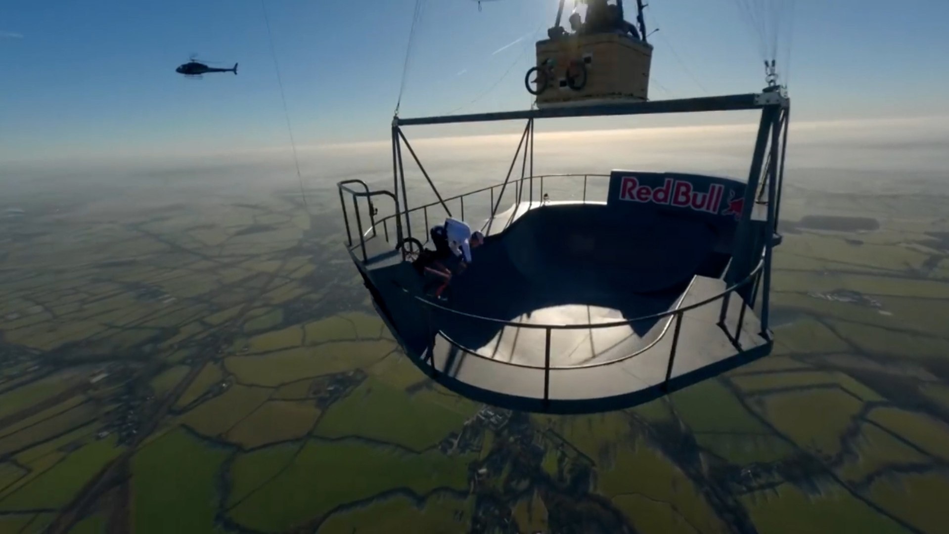 Insane bike stunt performed by Red Bull athlete 2,000 feet in the air suspended by hot air balloon