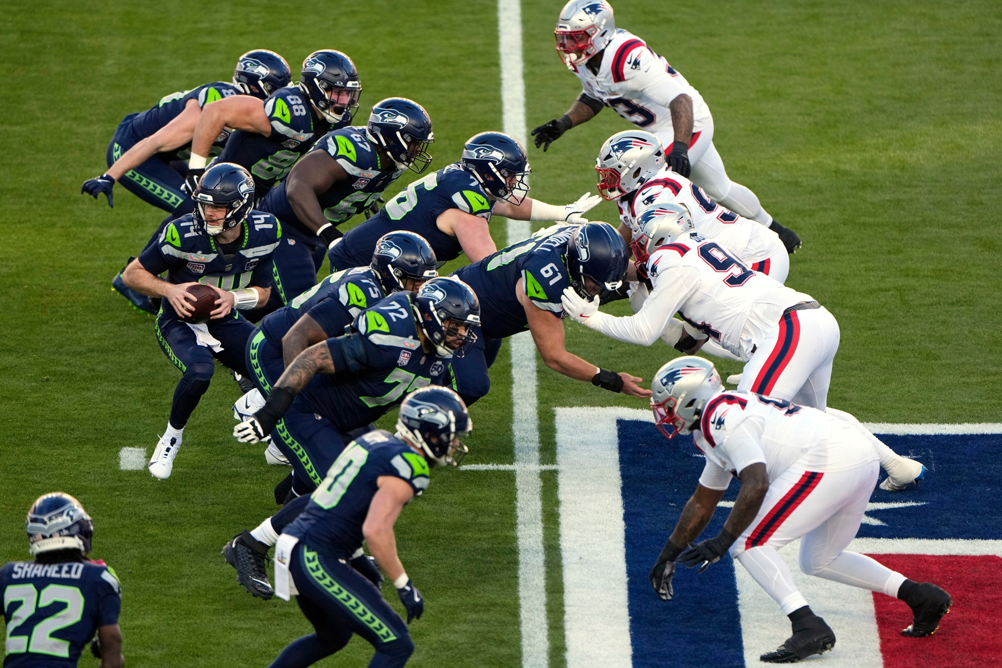 The Seattle Seahawks and the New England Patriots, right, face off during the NFL Super Bowl 60