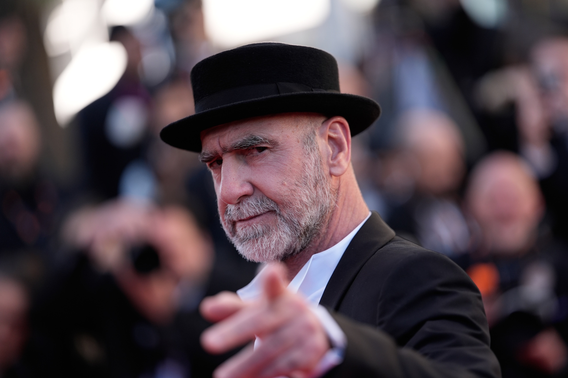 Eric Cantona poses for photographers upon arrival at the premiere of the film 'The Beloved'.