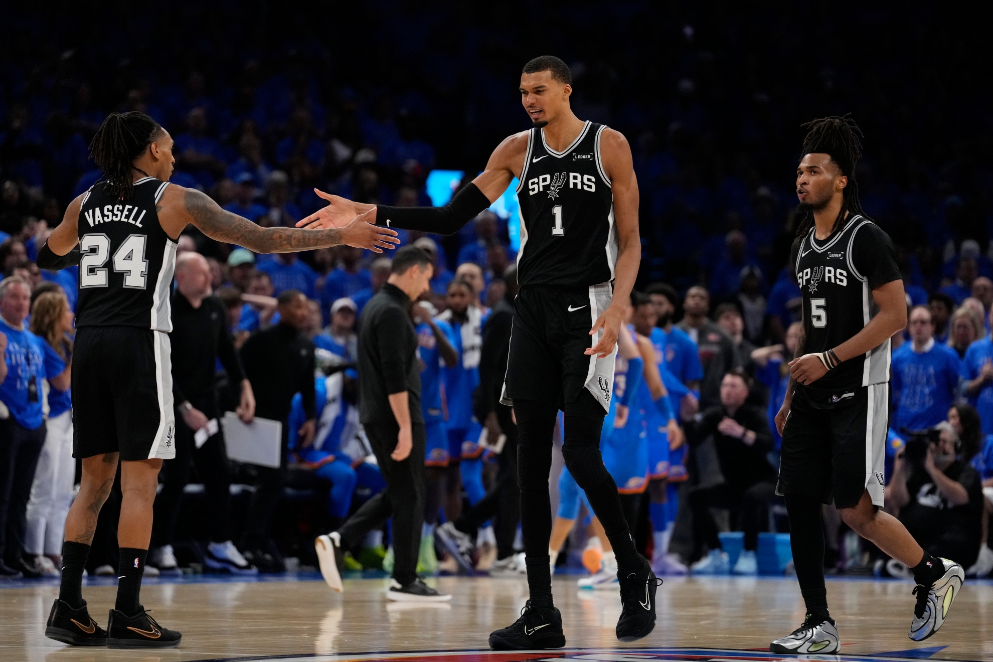 San Antonio Spurs forward Victor Wembanyama (1) celebrates with guard Devin Vassell (24) and guard Stephon Castle (5) during the NBA playoff series against the Oklahoma City Thunder
