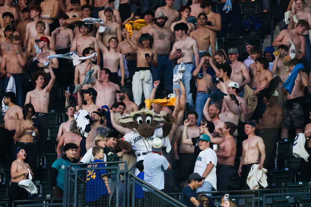 Seattle Mariners mascot Moose goes "tarps off" with fans in the bottom of the seventh inning of a baseball game against the Chicago White Sox, Tuesday, May 19, 2026, in Seattle. (AP Photo/Kevin Ng)