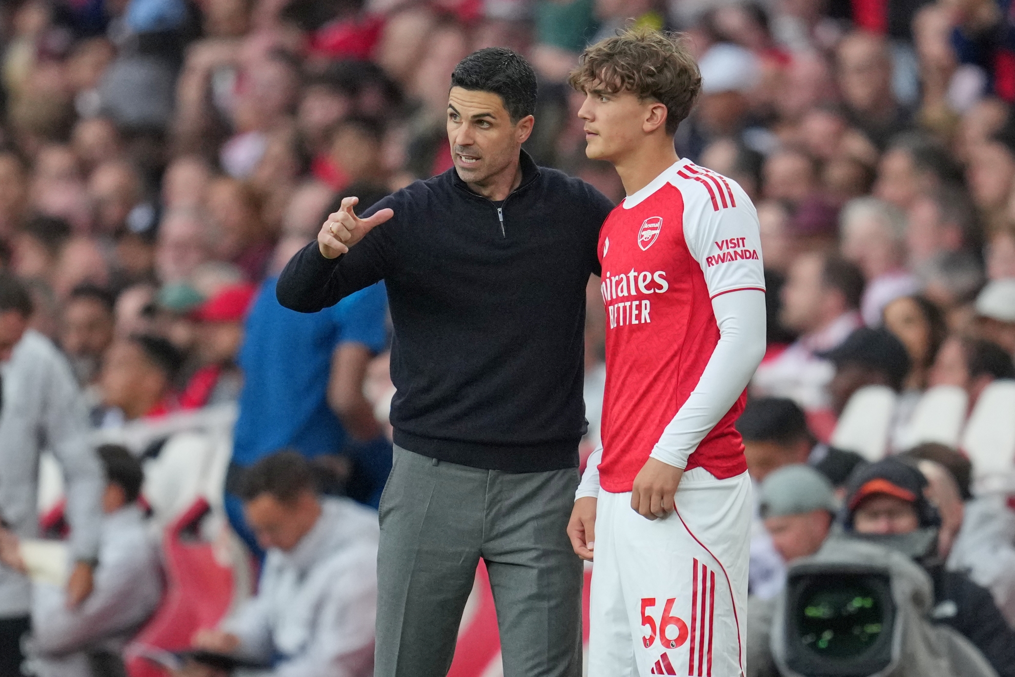 Arsenal's manager Mikel Arteta talks to Arsenal's Max Dowman during the English Premier League soccer match between Arsenal and Fulham