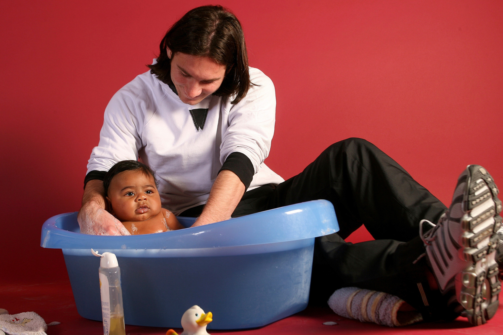 Lionel Messi bathes Lamine Yamal as a baby during a UNICEF photo shoot.