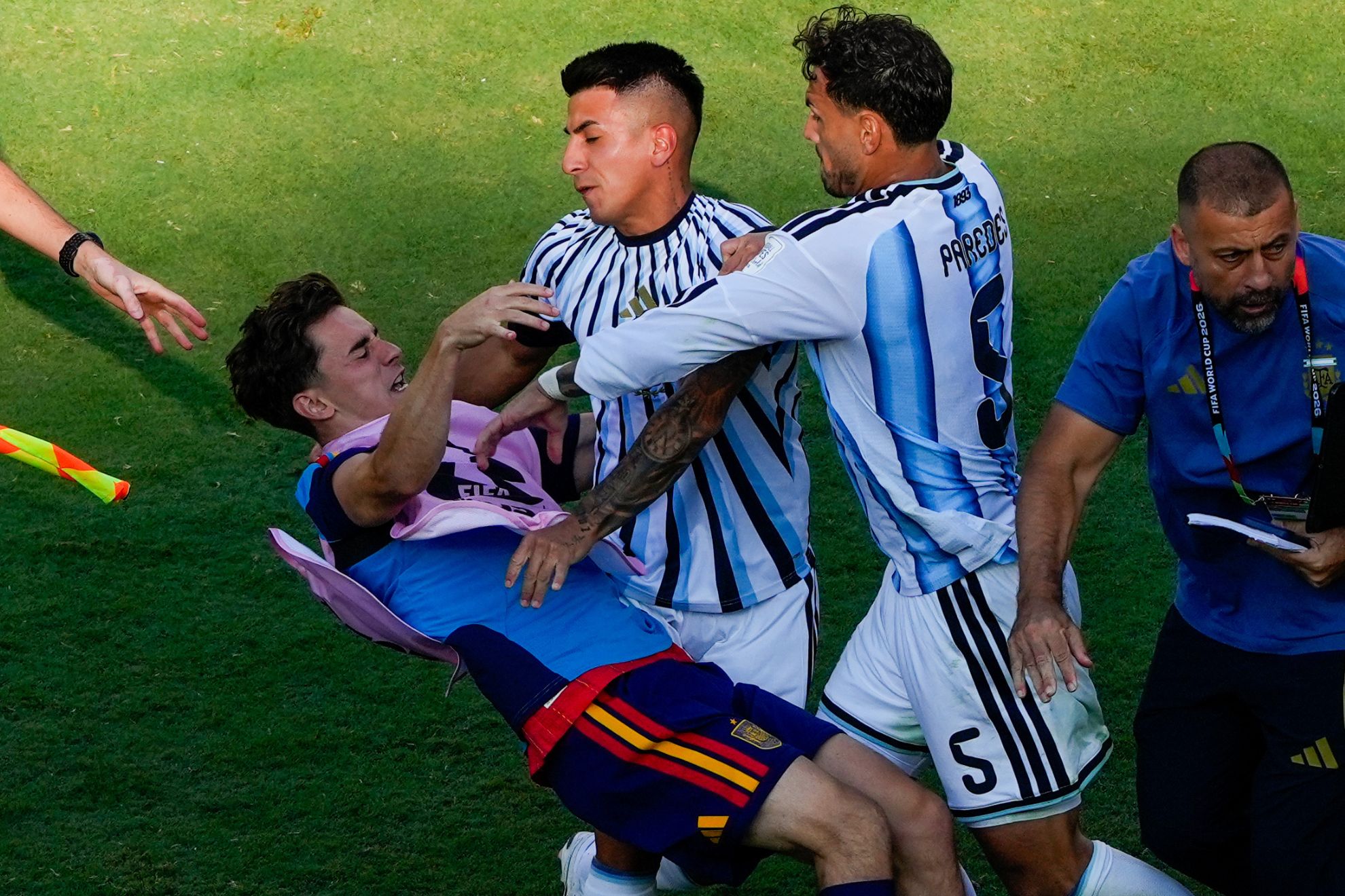 Spain's Gavi, left, falls as he scuffles with Argentina's Leandro Paredes (5)