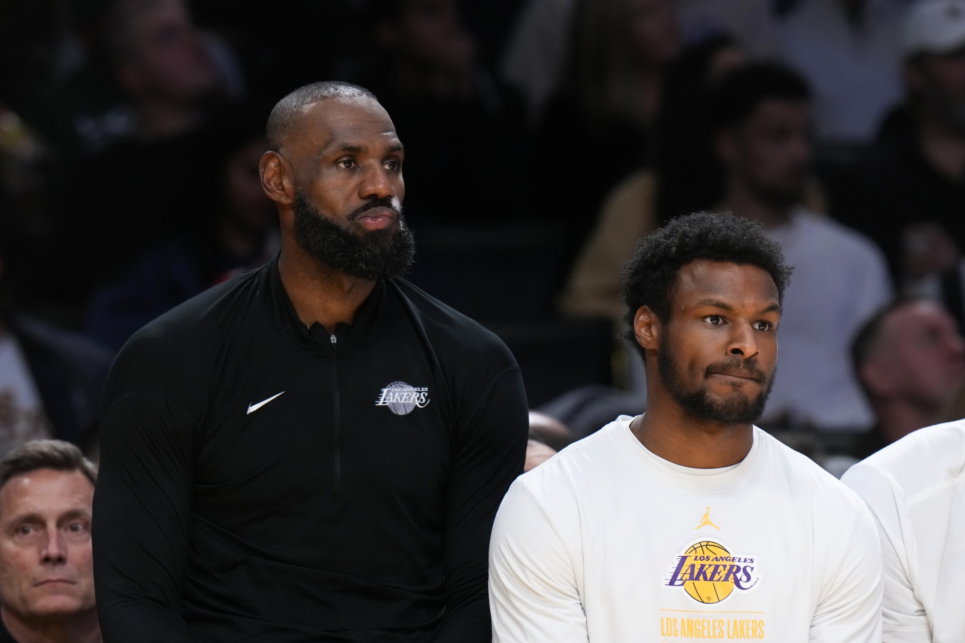 Lebron James, left, and guard Bronny James sit on the bench Lapresse