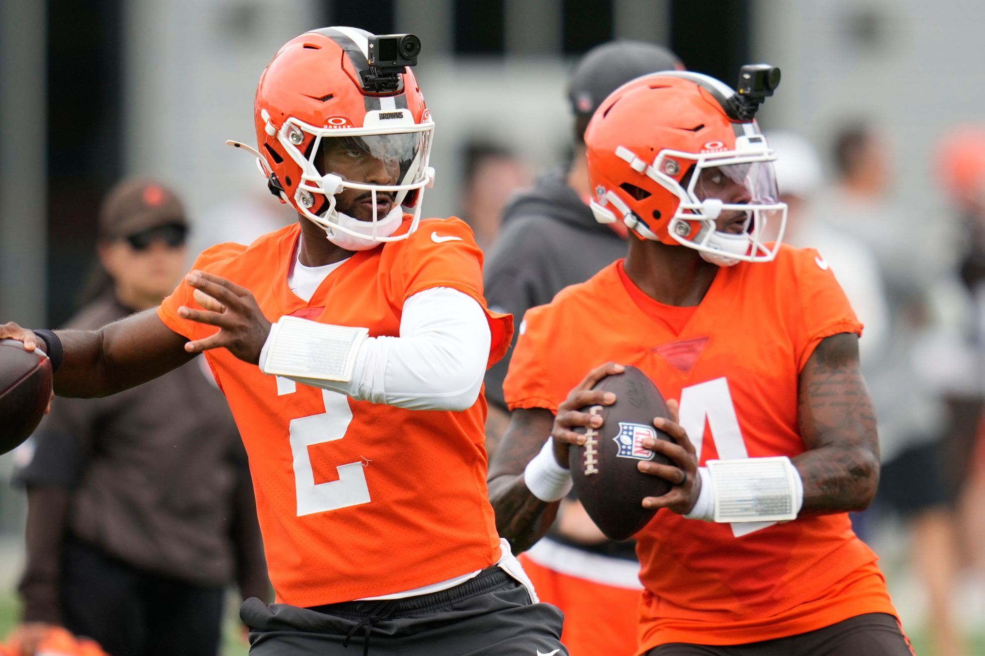 Cleveland Browns quarterbacks Shedeur Sanders, left, and Deshaun Watson, right.