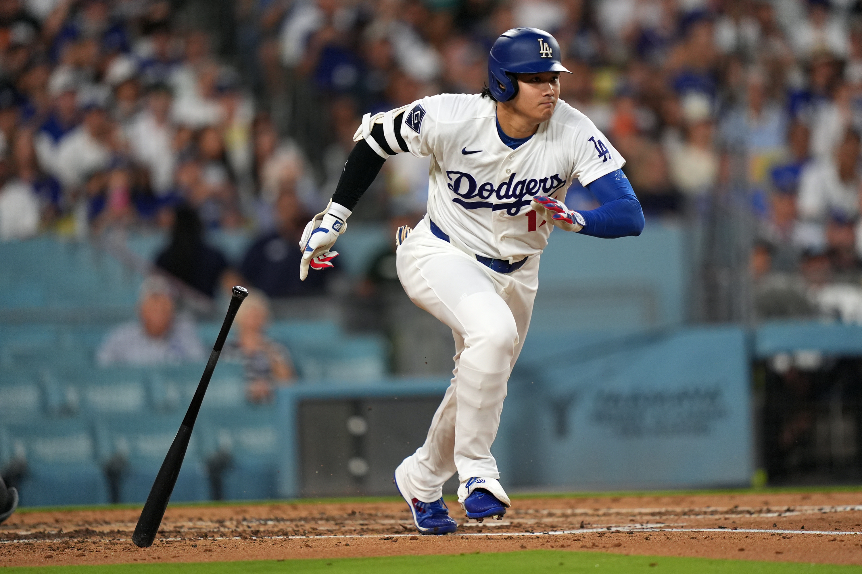 Los Angeles Dodgers' Shohei Ohtani (17) watches his single against the Seattle Mariners during the third inning of a baseball game Wednesday, July 29, 2026, in Los Angeles. (AP Photo/Scott Strazzante)
