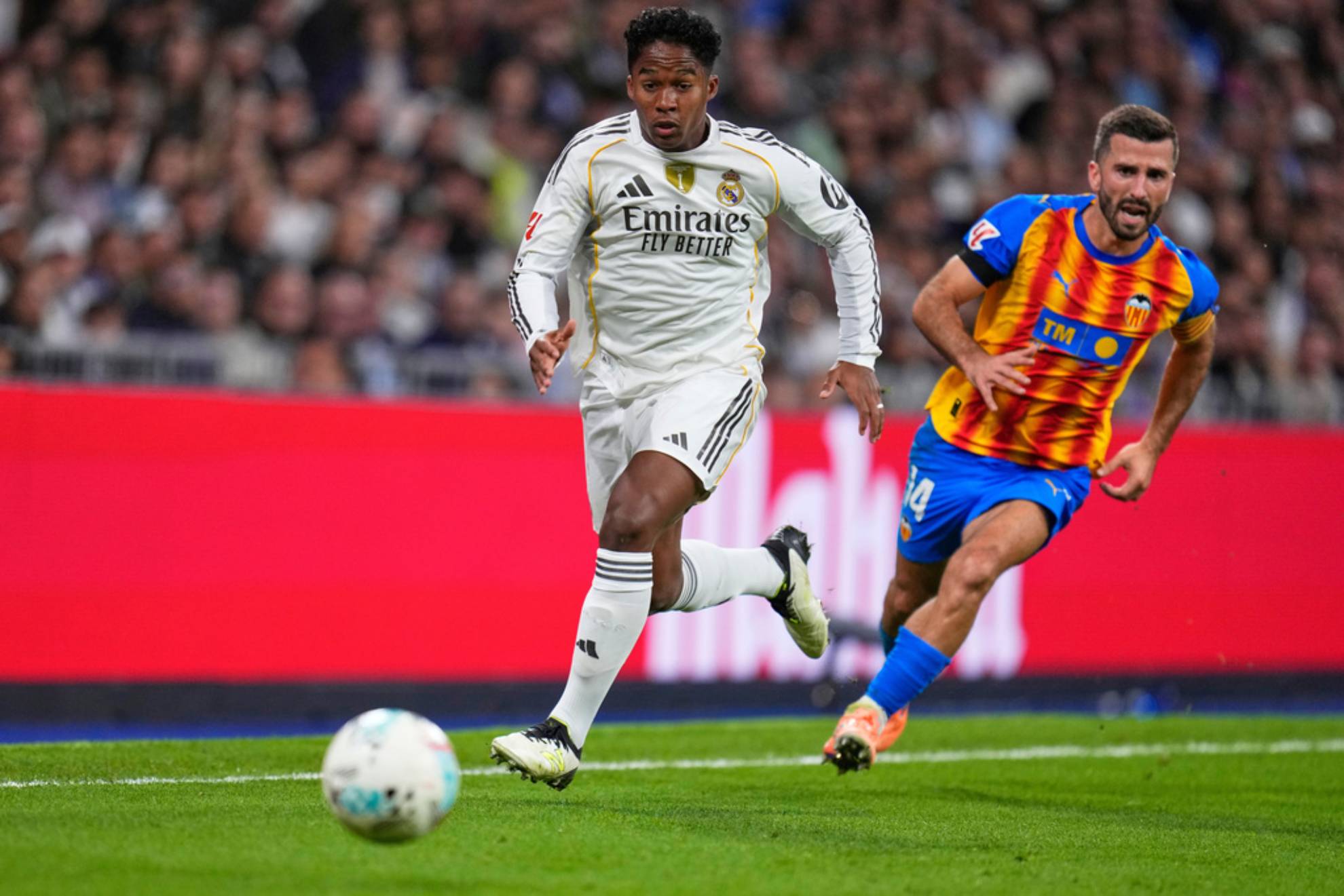 Real Madrid's Endrick, left, and Valencia's Jose Gaya challenge for the ball during the Spanish La Liga soccer match between Real Madrid and Valencia in Madrid. Manu Fernandez