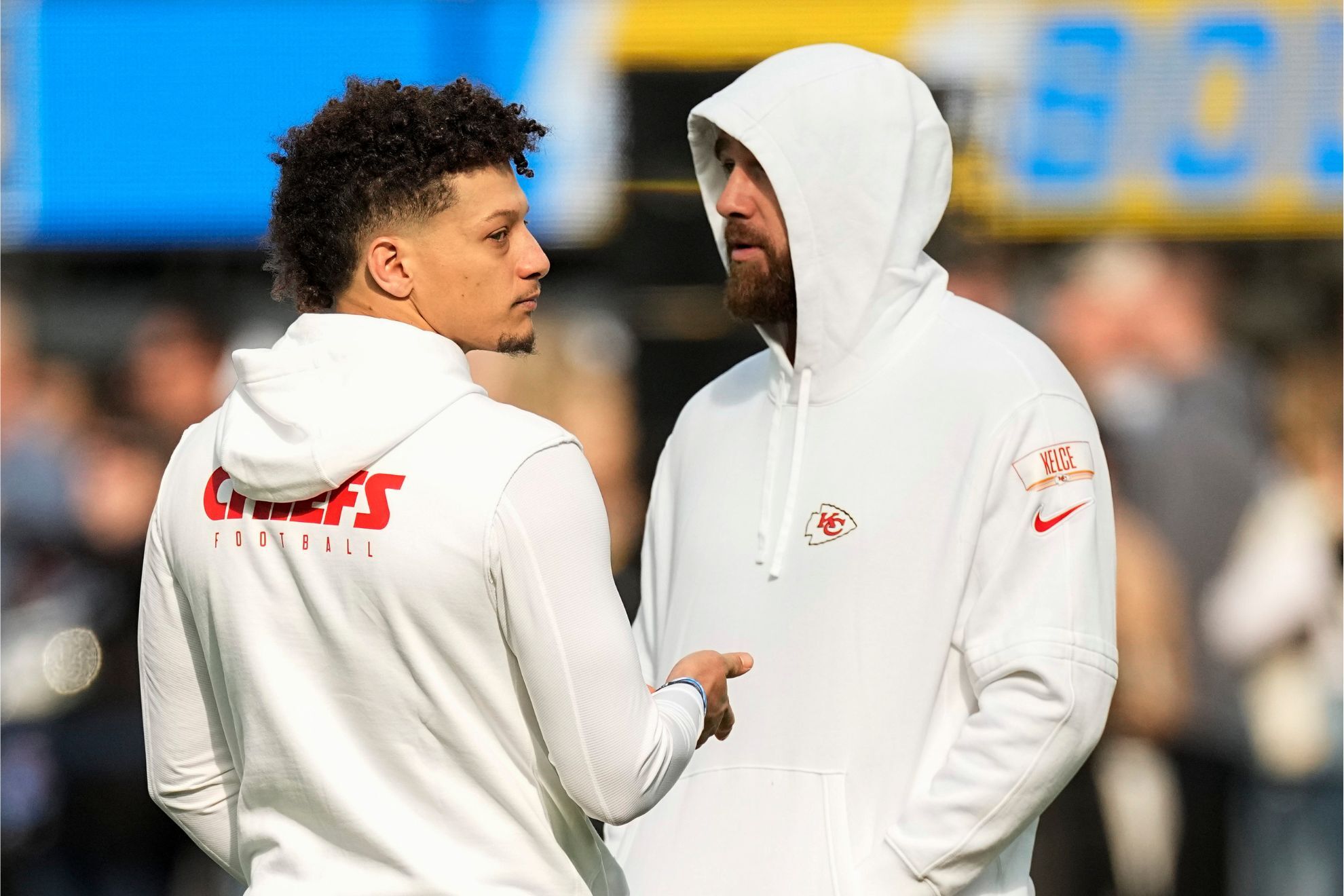 Patrick Mahomes, talks with tight end Travis Kelce before an NFL football game