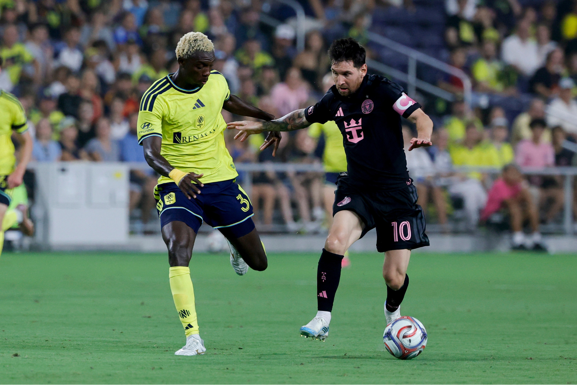 Lionel Messi is defended during the Nashville SC vs. Inter Miami MLS match.
