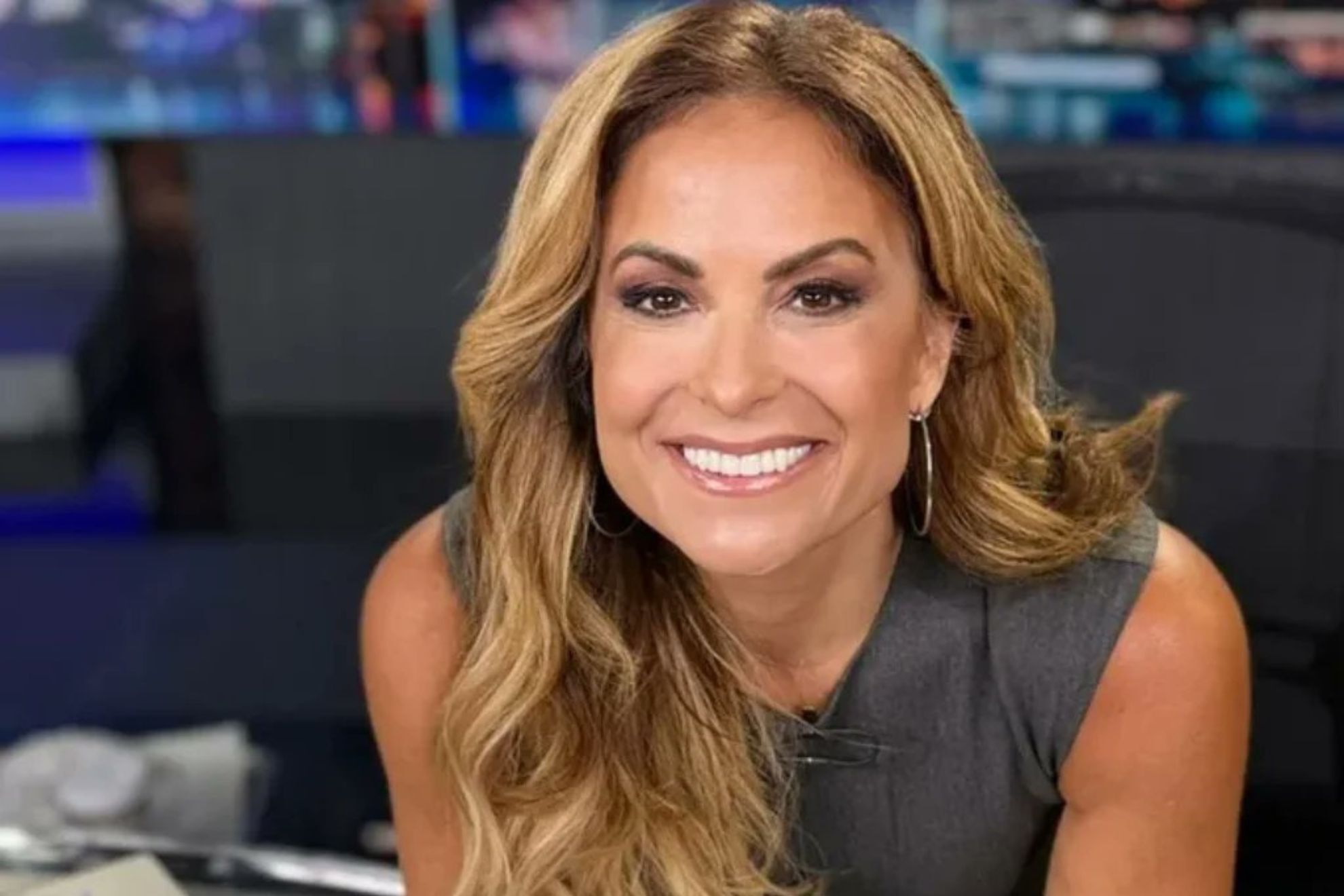 Taryn Asher as a TV news anchor