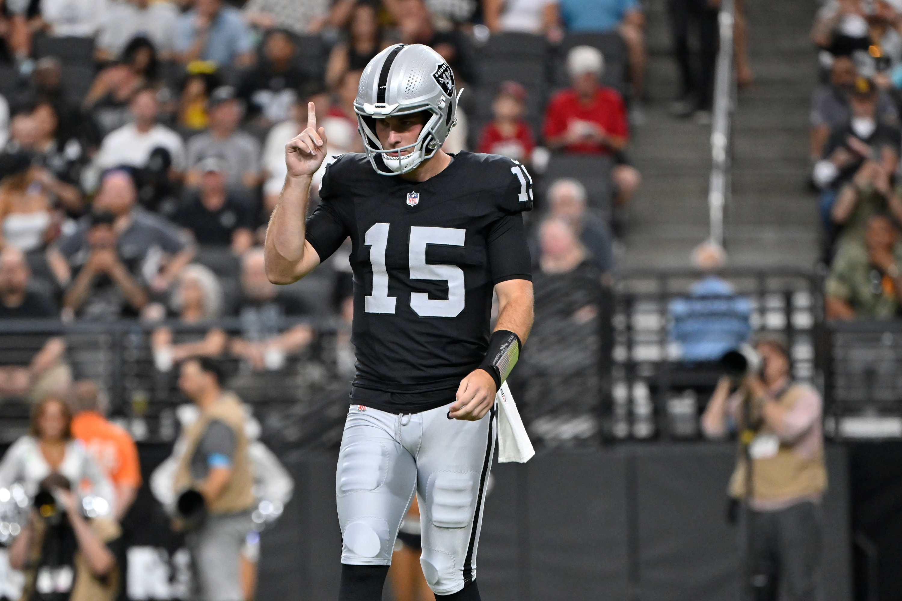 Las Vegas Raiders quarterback Fernando Mendoza (15) pauses on the field during the first half of a preseason NFL football game against the Arizona Cardinals, Thursday, Aug. 13, 2026, in Las Vegas. (AP Photo/David Becker) David Becker
