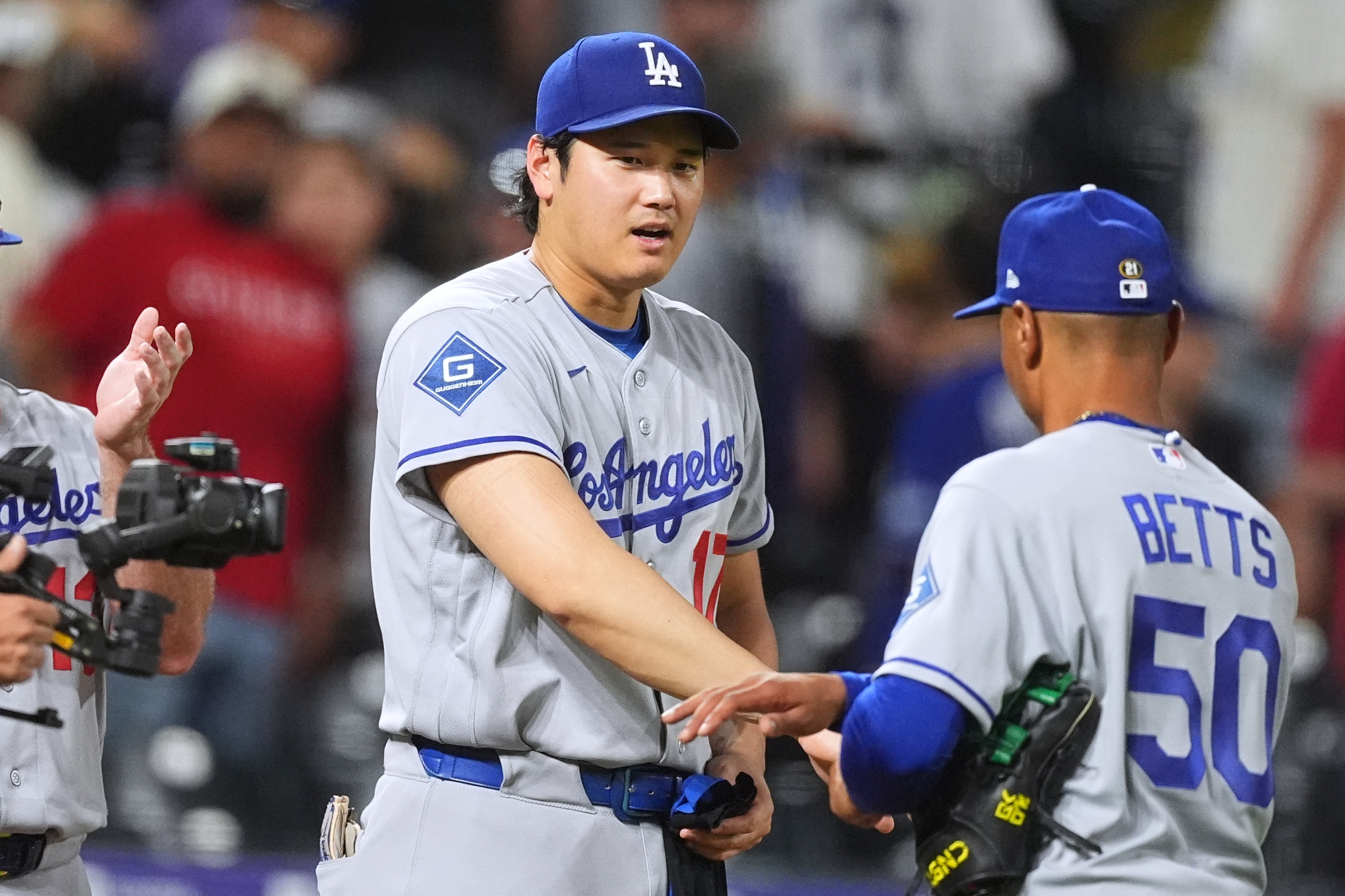 Los Angeles Dodgers' Shohei Ohtani, left, congratulates shortstop Mookie Betts after defeating the Colorado Rockies in a baseball game Wednesday, Aug. 19, 2026, in Denver. (AP Photo/David Zalubowski) AP Photo/David Zalubowski