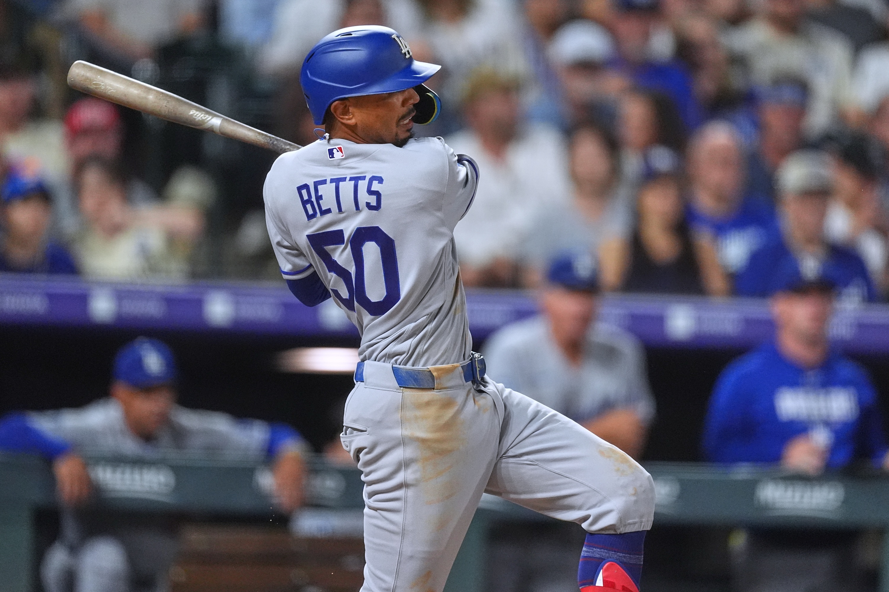 Los Angeles Dodgers' Mookie Betts connects for an RBI single off Colorado Rockies relief pitcher Jimmy Herget in the 10th inning of a baseball game Wednesday, Aug. 19, 2026, in Denver. (AP Photo/David Zalubowski) AP Photo/David Zalubowski