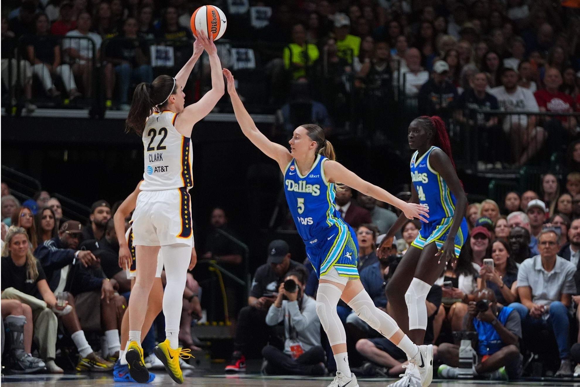 Indiana Fever guard Caitlin Clark (22) goes up to shoot against Dallas Wings guard Paige Bueckers (5) during the first half of a WNBA basketball game