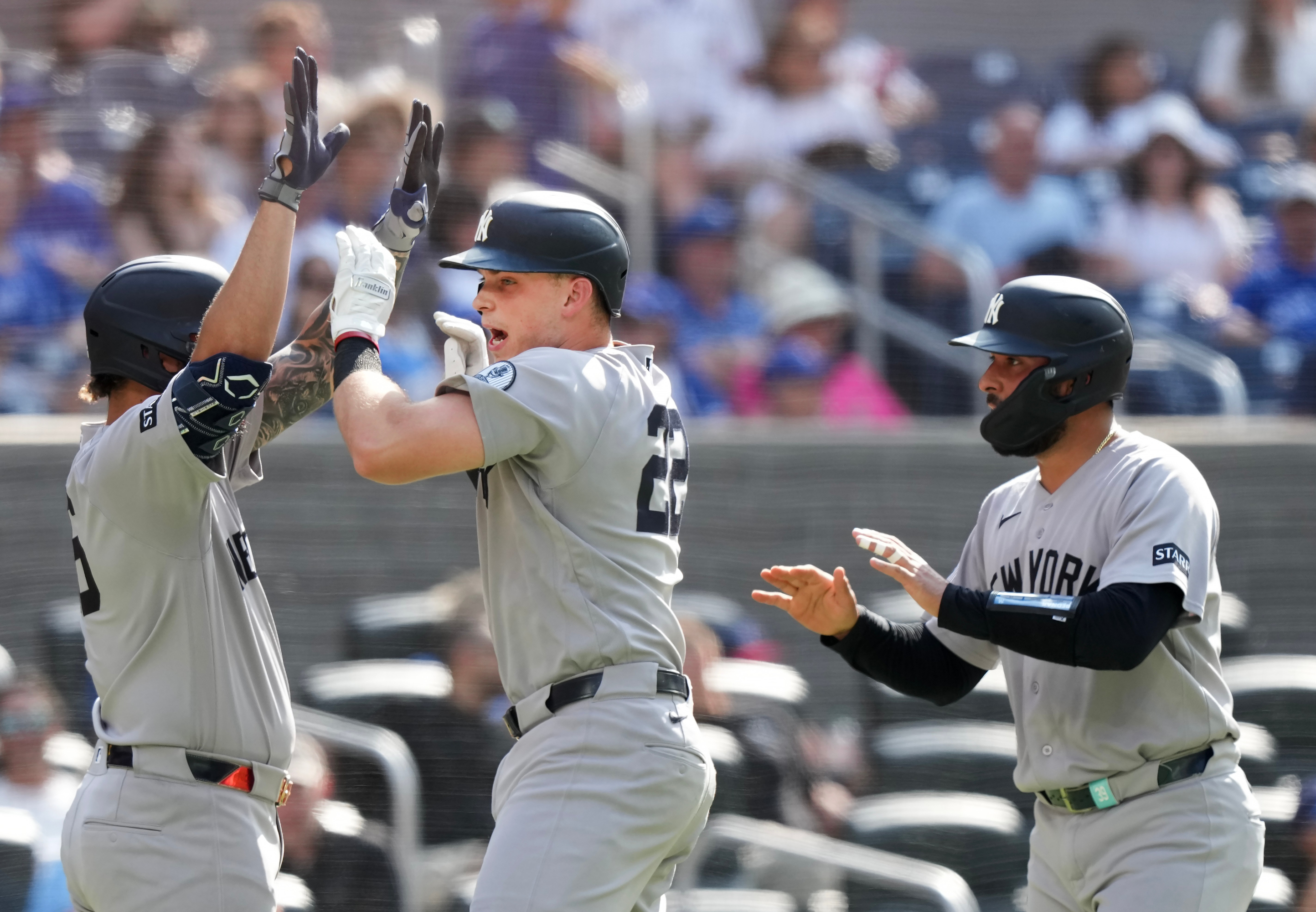 New York Yankees' Ben Rice, center, celebrates with teammates Luis Garcia Jr., left, and Ali Sanchez, right, after hitting the winning two-run home run against the Toronto Blue Jays during the 10th inning of a baseball game in Toronto, Sunday, Aug. 16, 2026. (Nathan Denette/The Canadian Press via AP) Nathan Denette