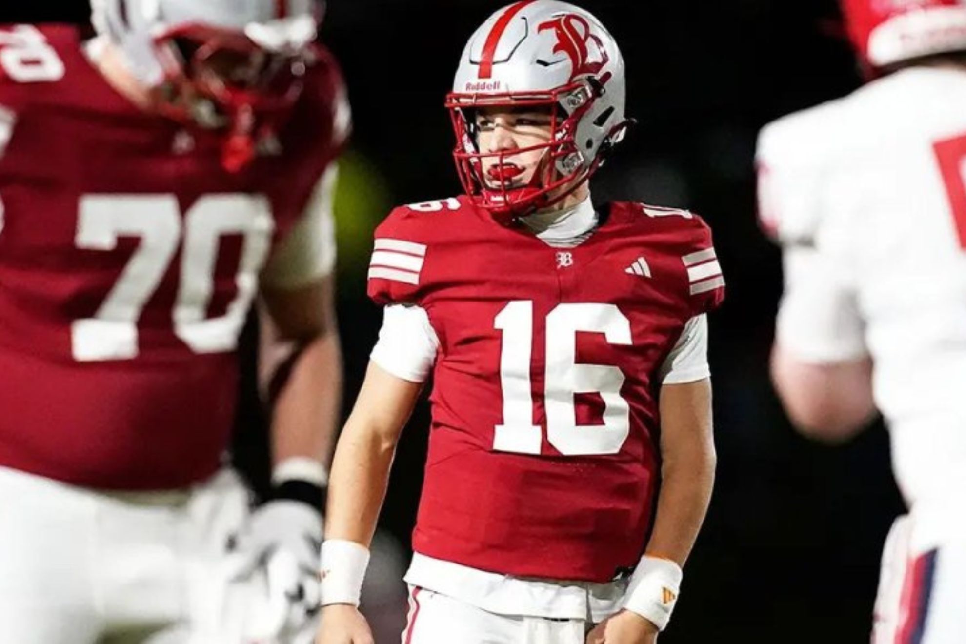 Marshall Manning walking across the field during a high school football game
