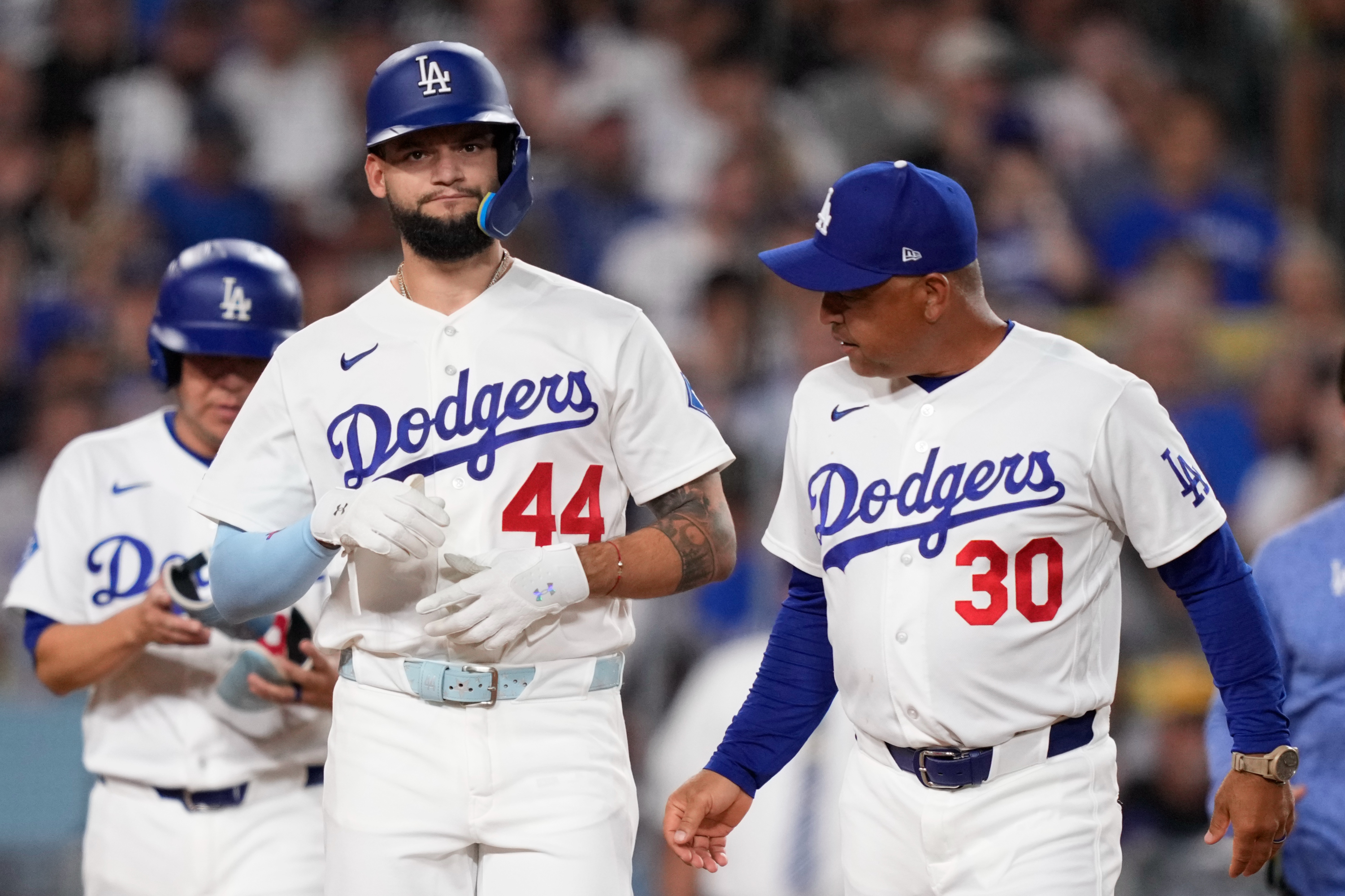 Los Angeles Dodgers' Andy Pages, walks to first with manager Dave Roberts after being hit by a pitch during the third inning of a baseball game against the Pittsburgh Pirates, Friday, Aug. 21, 2026, in Los Angeles. (AP Photo/Mark J. Terrill) Mark J. Terrill