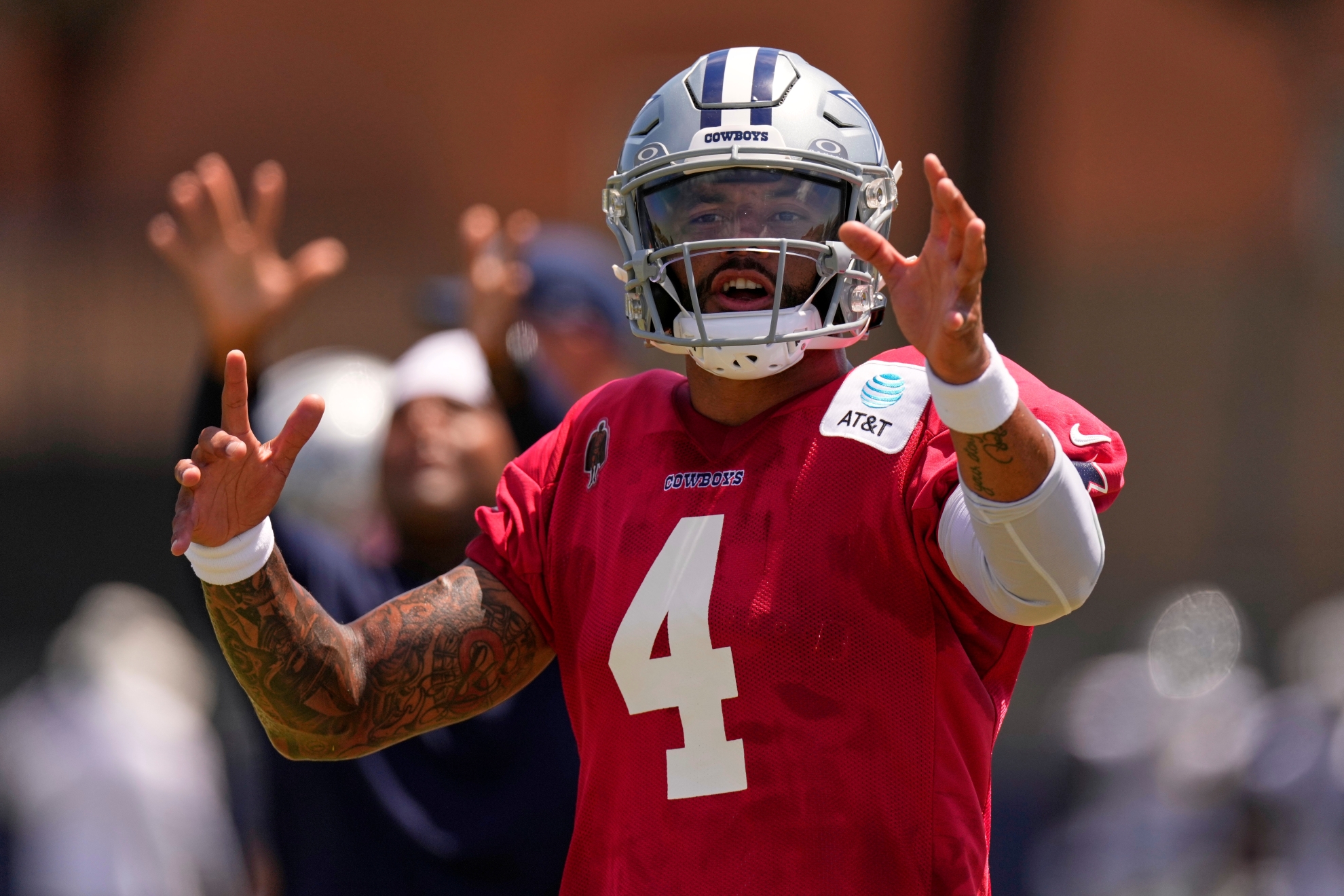 Dallas Cowboys quarterback Dak Prescott gestures during the NFL football team's training camp
