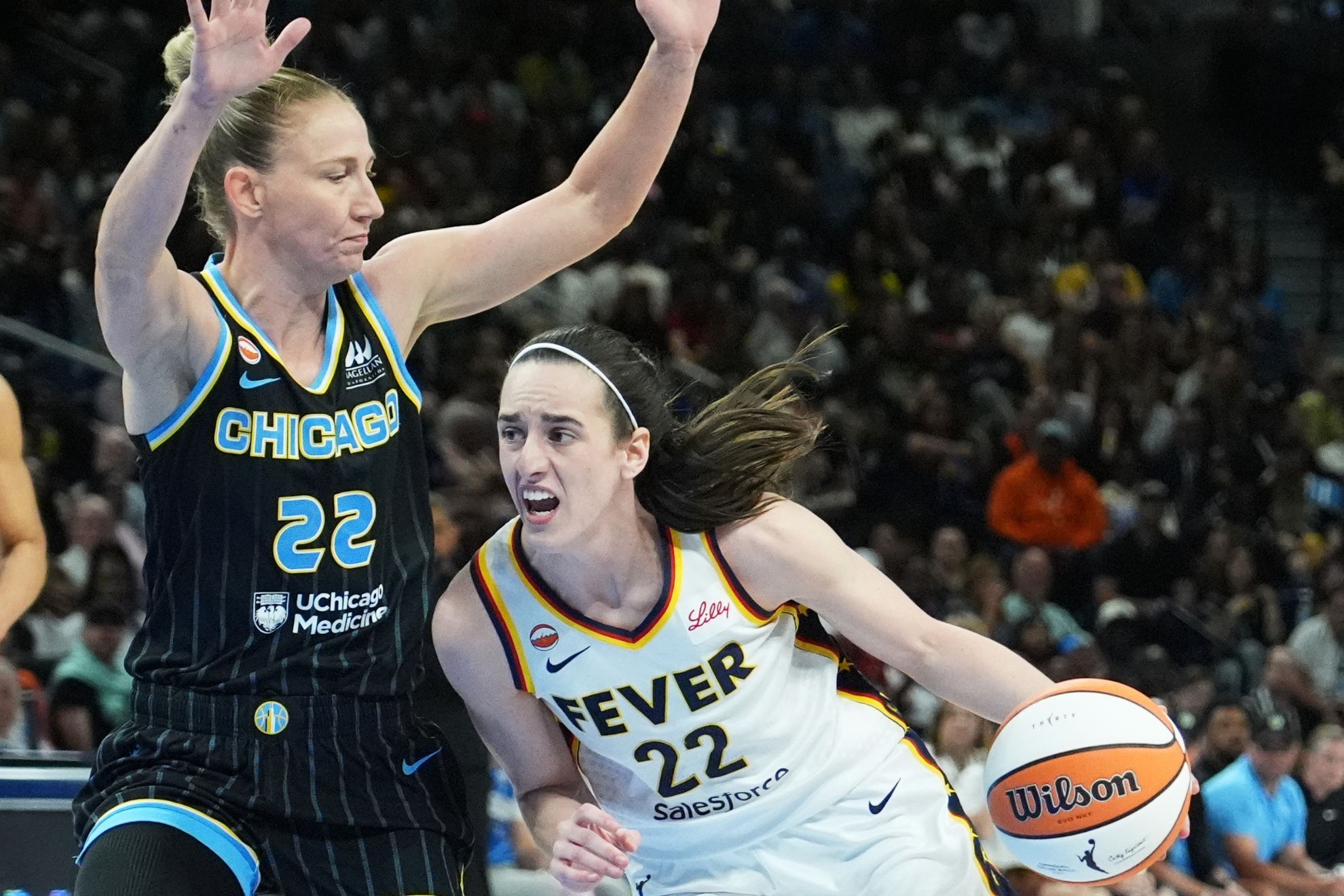 Indiana Fever guard Caitlin Clark, right, drives against Chicago Sky guard Courtney Vandersloot, left