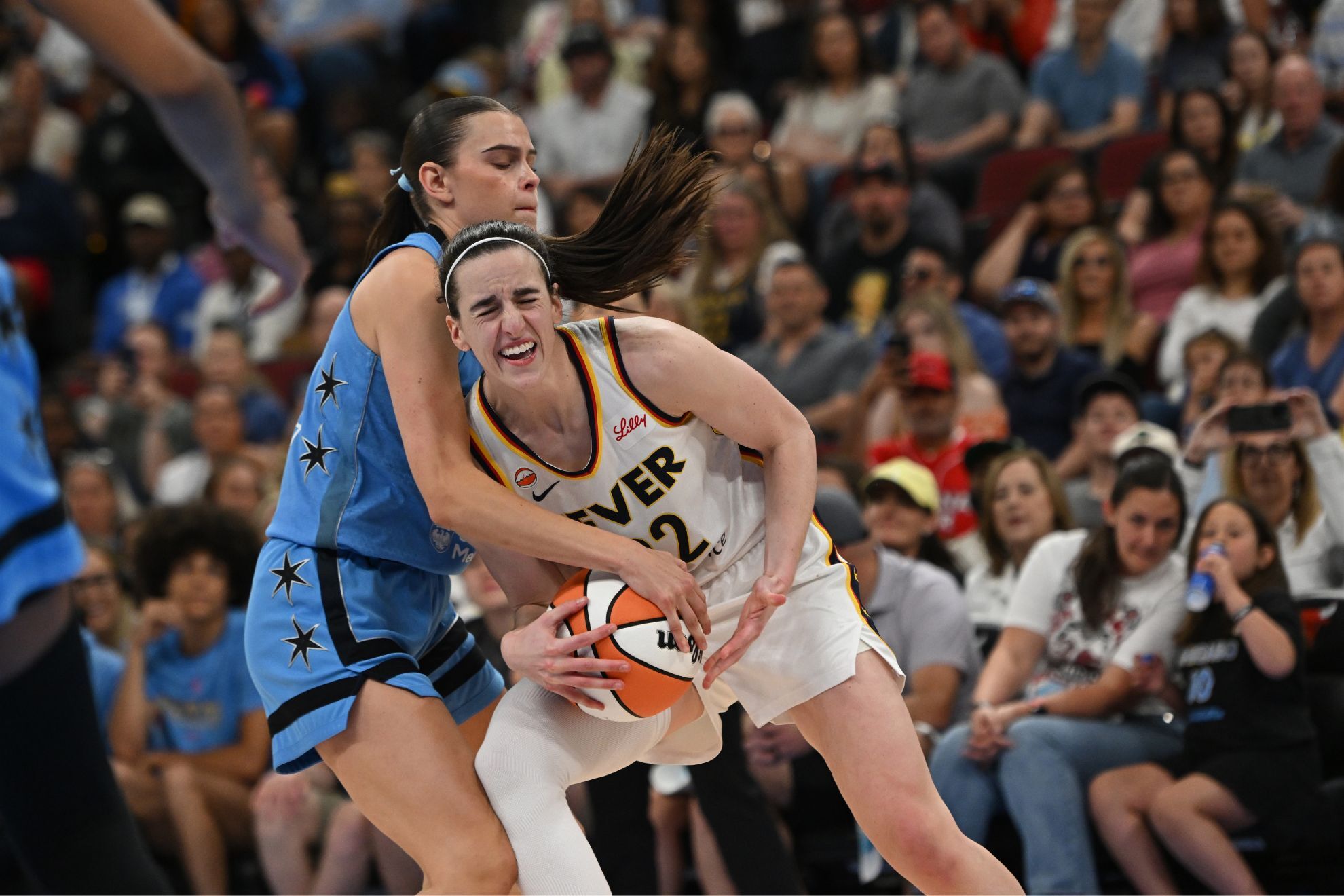 Caitlin Clark battles Chicago Sky's Gabriela Jaquez for control of the ball during the second half of a WNBA basketball game