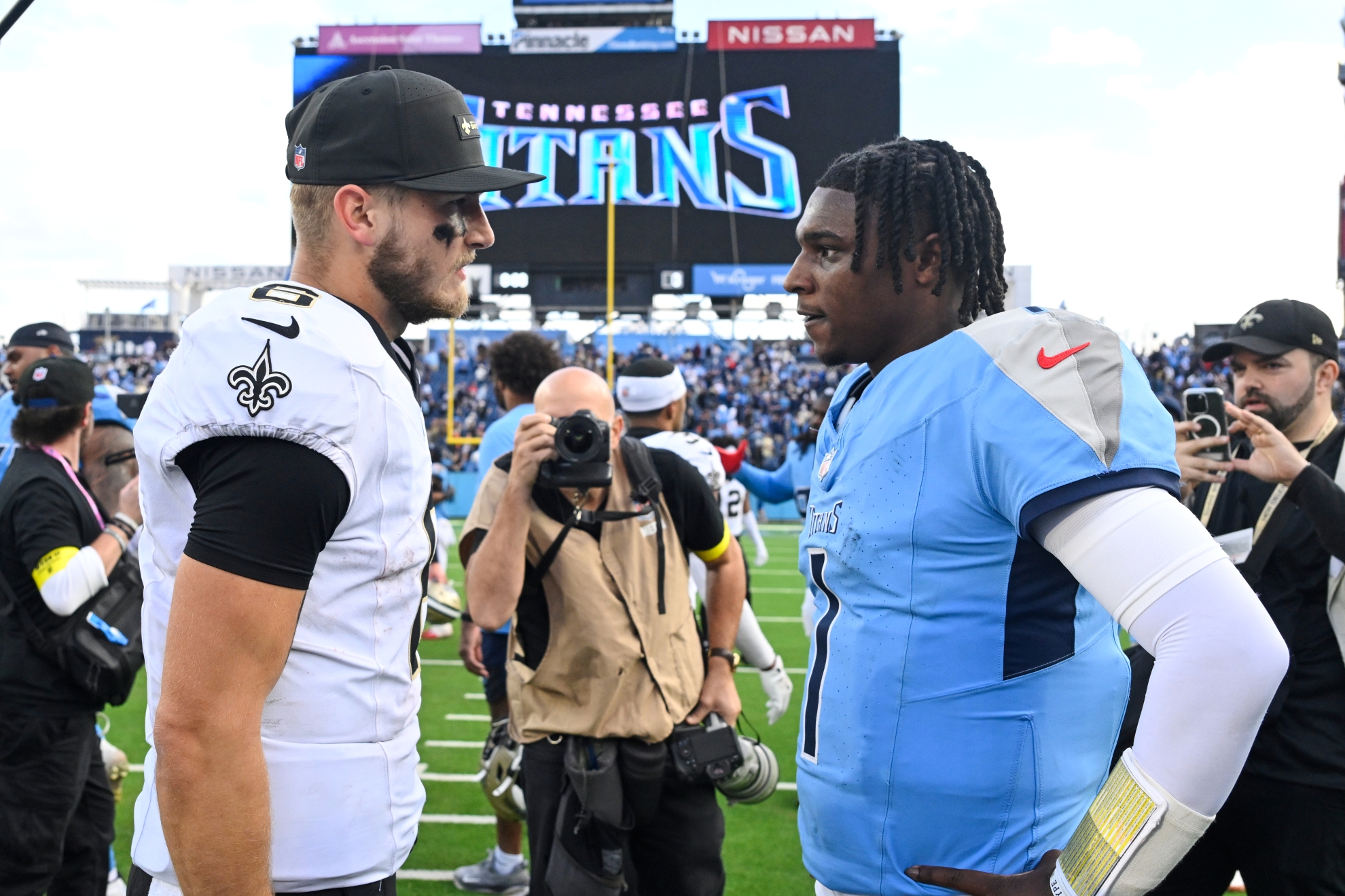 New Orleans Saints quarterback Tyler Shough (6) greets Tennessee Titans quarterback Cam Ward (1) after an NFL football game