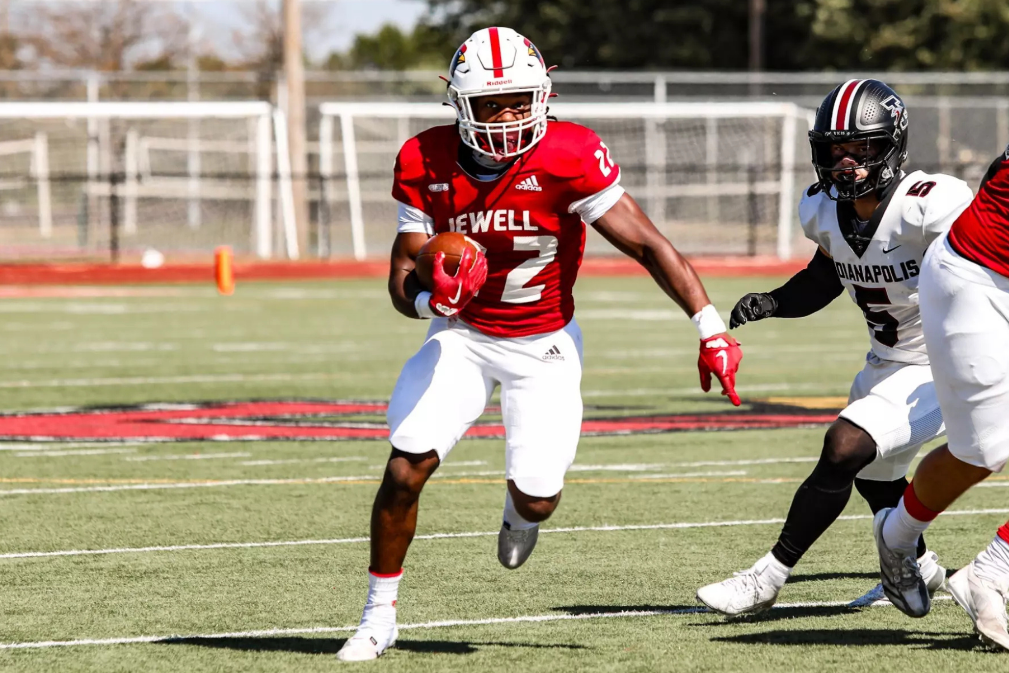 MicahJo Barnett carrying the ball on a rushing play for William Jewell College. William Jewell College Official Website