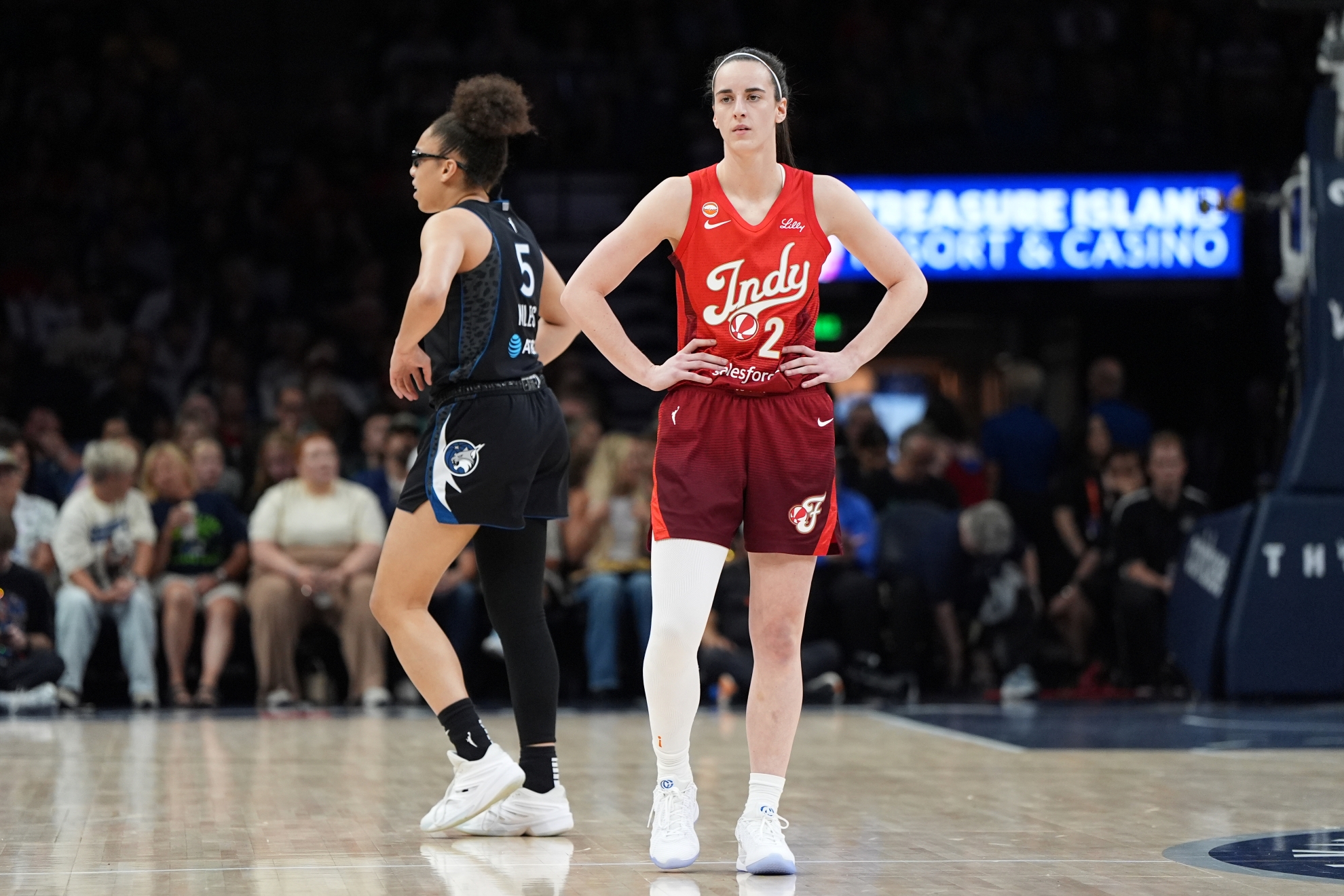Indiana Fever guard Caitlin Clark (22) stands on the court during a WNBA basketball game against the Minnesota Lynx