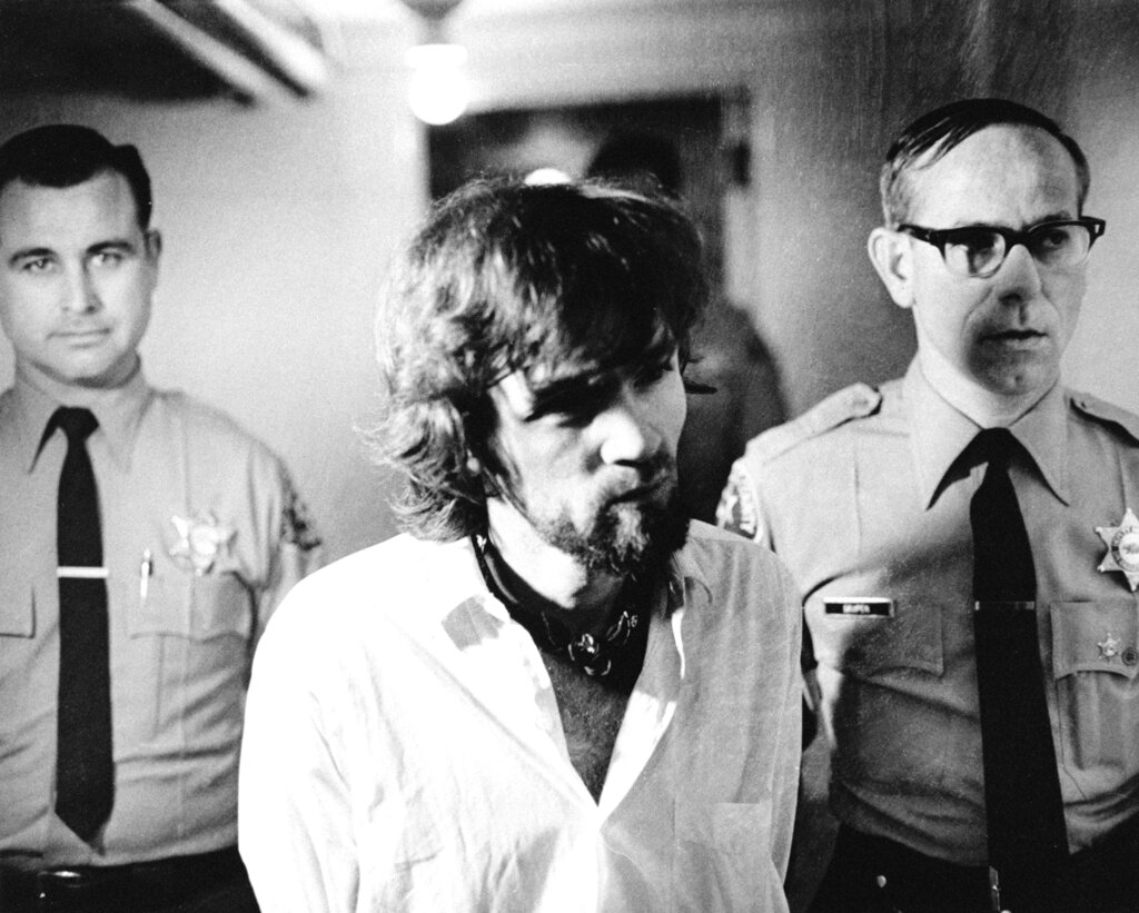 Accused killer Charles Manson is escorted to court by two deputies on what was the last day of the seven-month-old murder trial for Manson and three female defendants in Los Angeles, Jan. 15, 1971. The four are accused of seven murders, including that of actress Sharon Tate. The case is now in the hands of the jury. (AP Photo/Pool) LAPRESSE