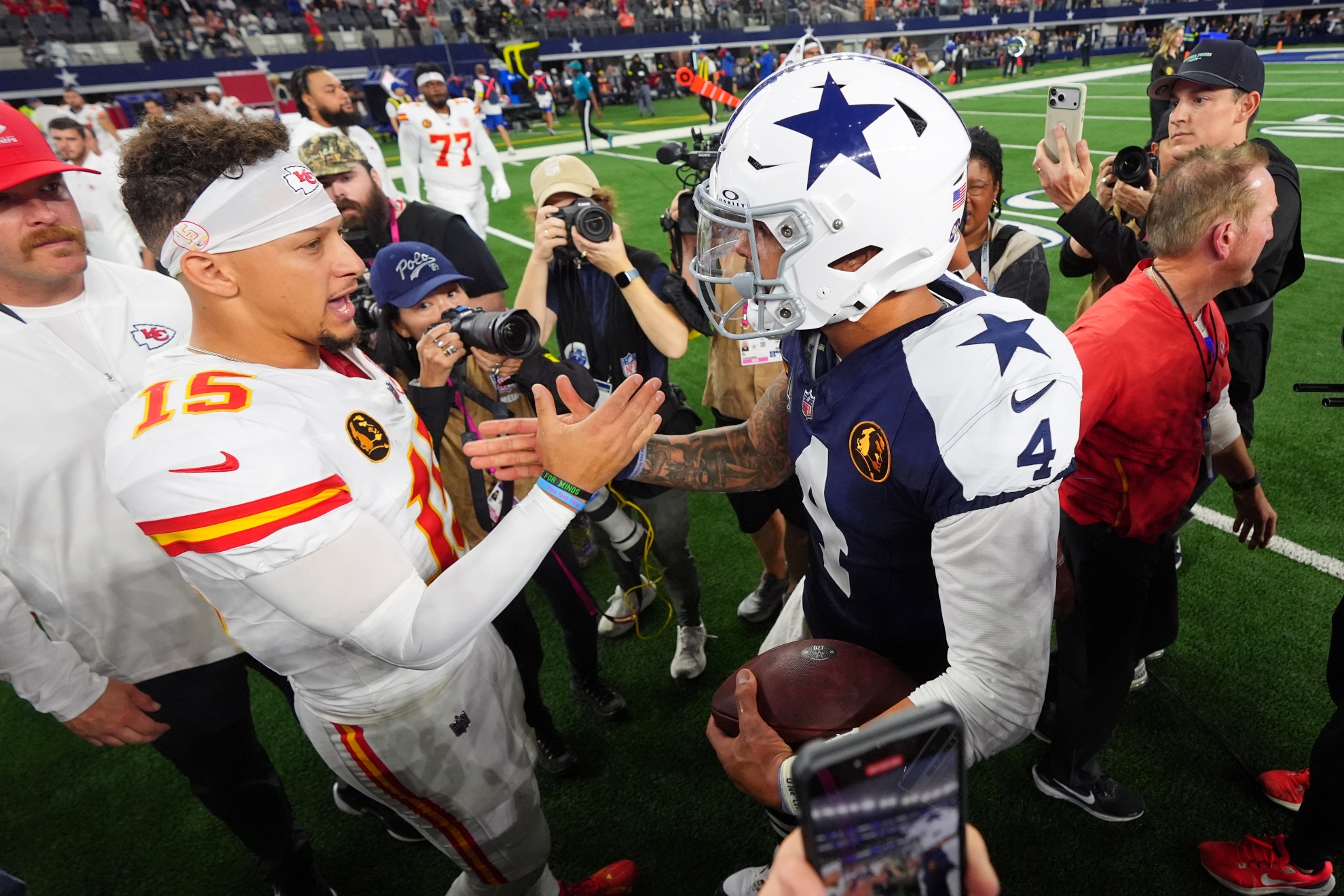 Kansas City Chiefs quarterback Patrick Mahomes (15) and Dallas Cowboys quarterback Dak Prescott (4) shake hands following an NFL football game