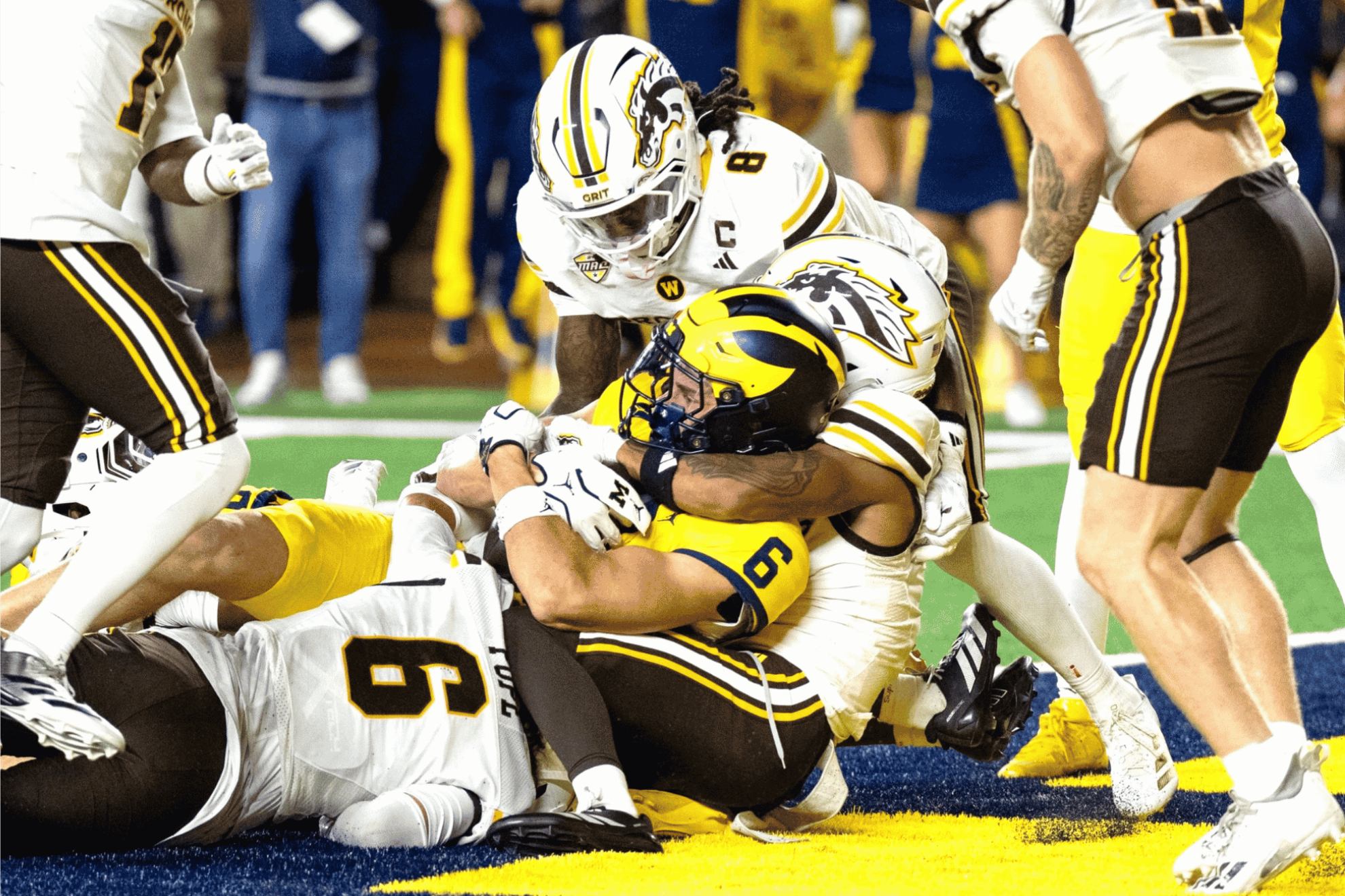 Michigan Wolverines tight end JJ Buchanan is tackled by Western Michigan defenders during their NCAA college football game at Michigan Stadium