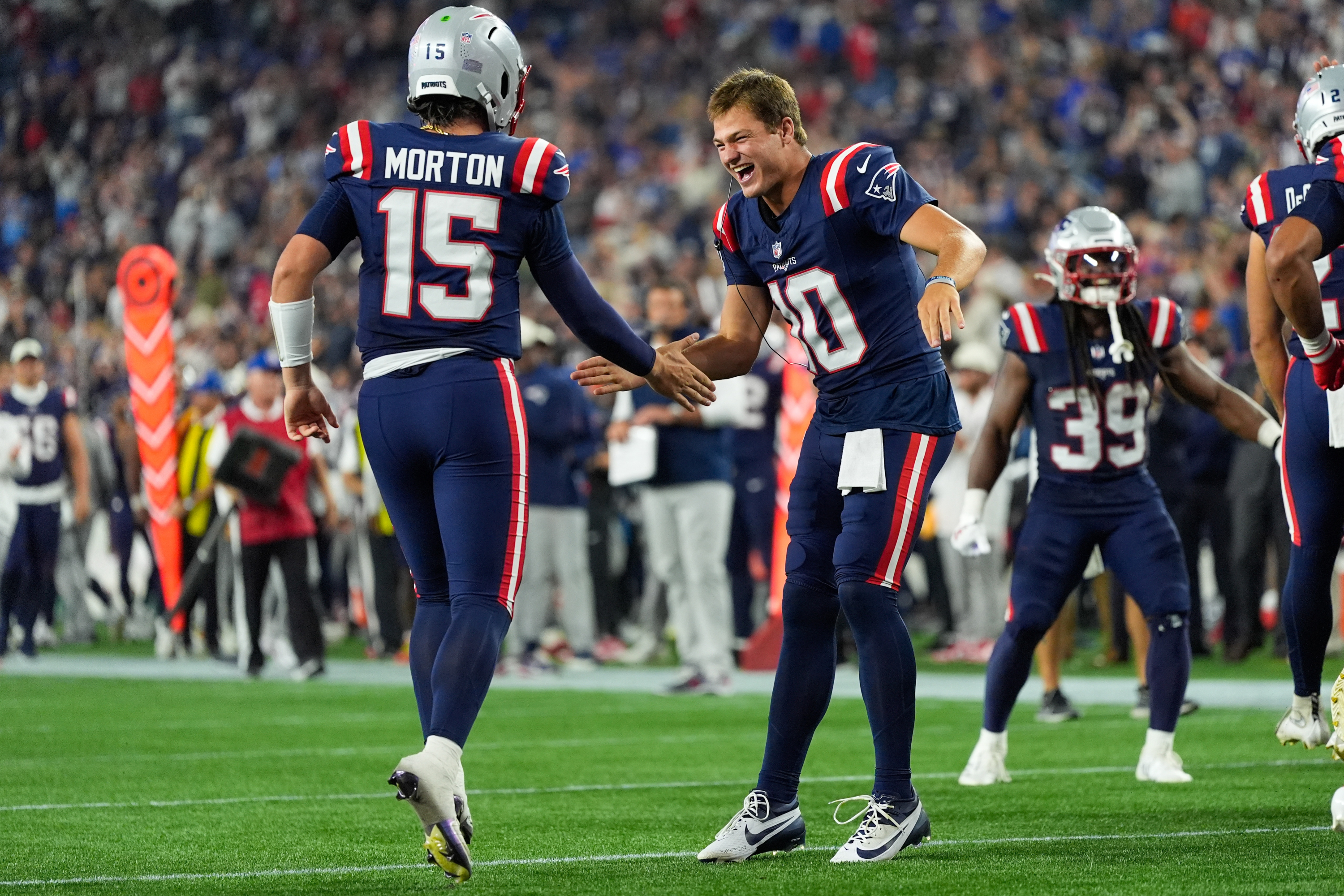 New England Patriots quarterback Behren Morton (15) celebrates his touchdown with quarterback Drake Maye(10) during the second half of an NFL preseason football game against the Philadelphia Eagles, Saturday, Aug. 22, 2026, in Foxborough, Mass. (AP Photo/Robert F. Bukaty) Robert F. Bukaty