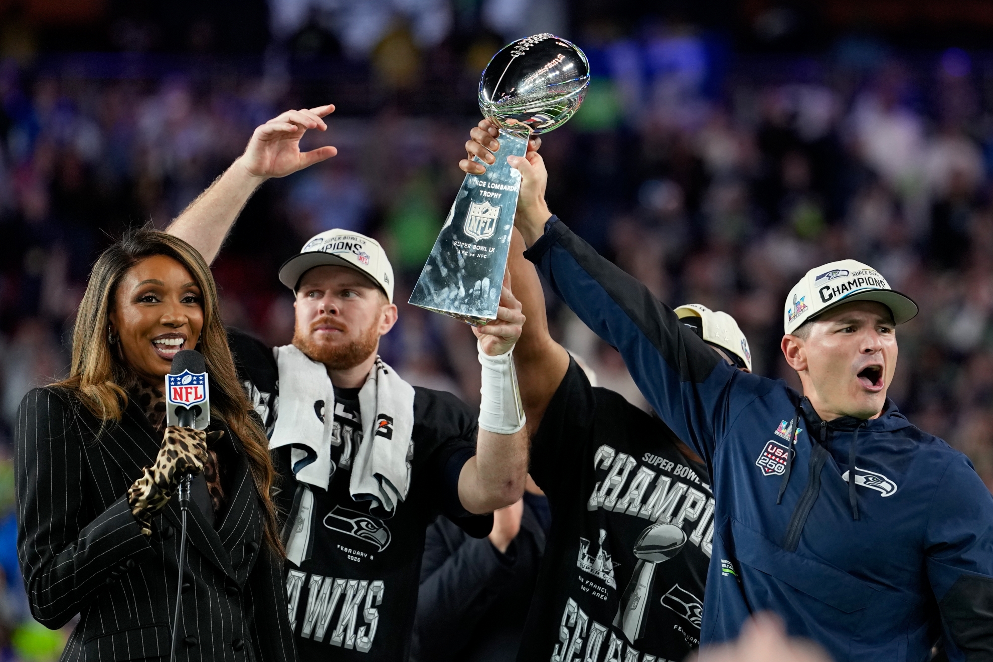 Seattle Seahawks head coach Mike Macdonald, right, and quarterback Sam Darnold lift the Lombardi Trophy after win over the New England Patriots in the NFL Super Bowl 60