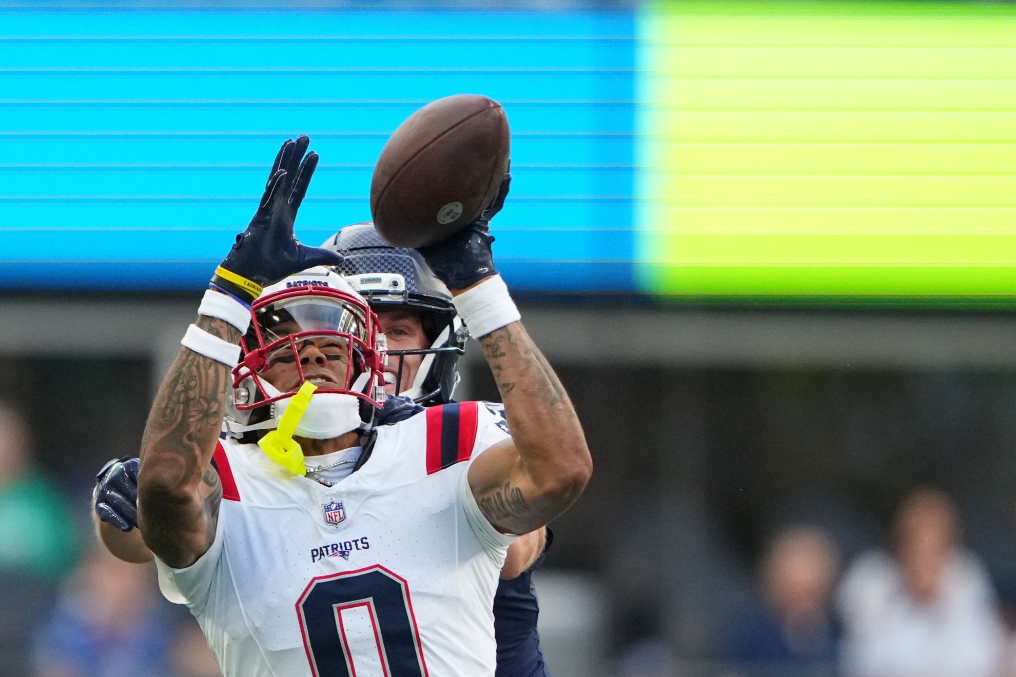 New England Patriots cornerback Christian Gonzalez, reaches for but misses a pass intended for Seattle Seahawks wide receiver Cooper Kupp