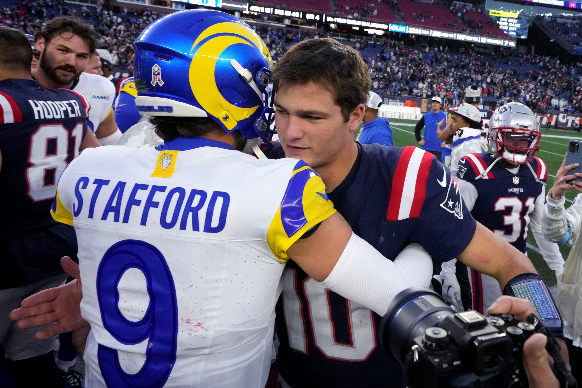 New England Patriots quarterback Drake Maye (10) is embraced by Los Angeles Rams quarterback Matthew Stafford (9)