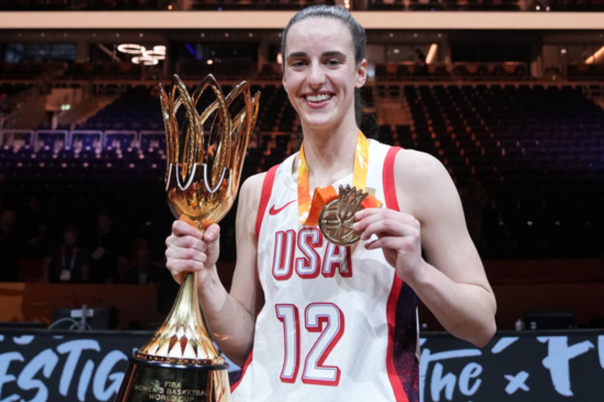 Caitlin Clark of the United States, poses with the trophy after the Women's Basketball World Cup final