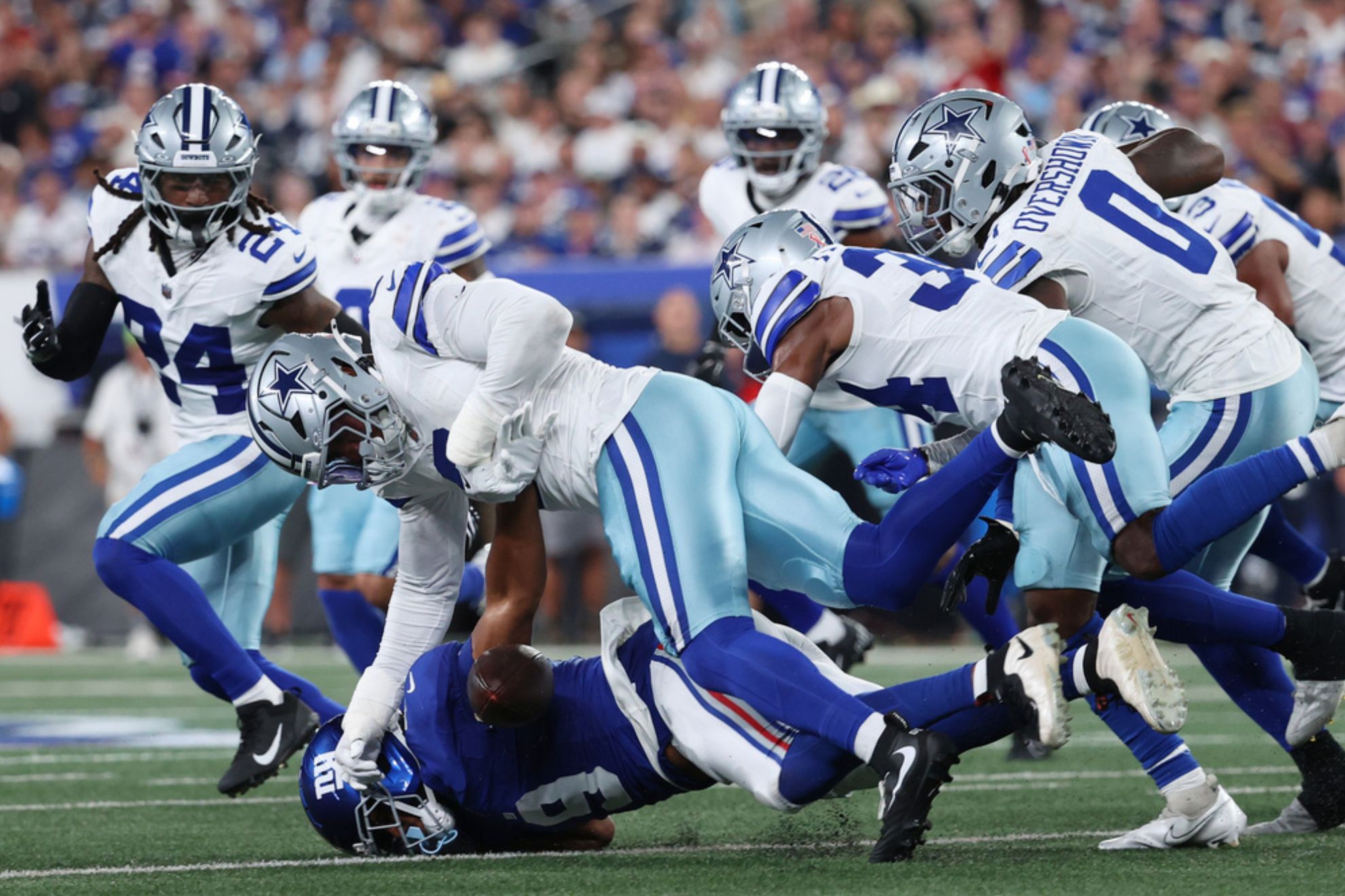 Dallas Cowboys players defend during the first half of an NFL football game Sunday
