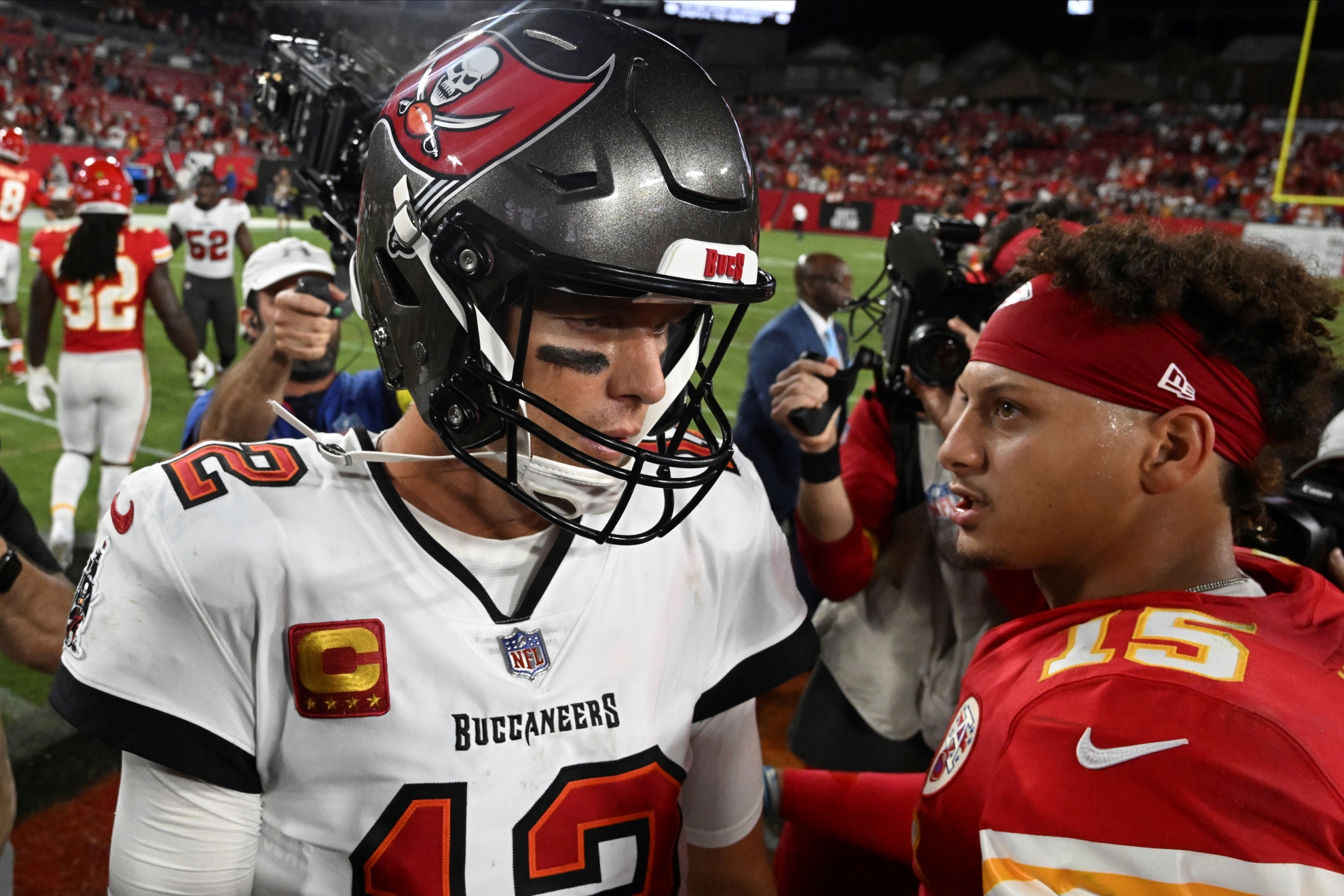 Tampa Bay Buccaneers quarterback Tom Brady (12) and Kansas City Chiefs quarterback Patrick Mahomes (15) greet each other