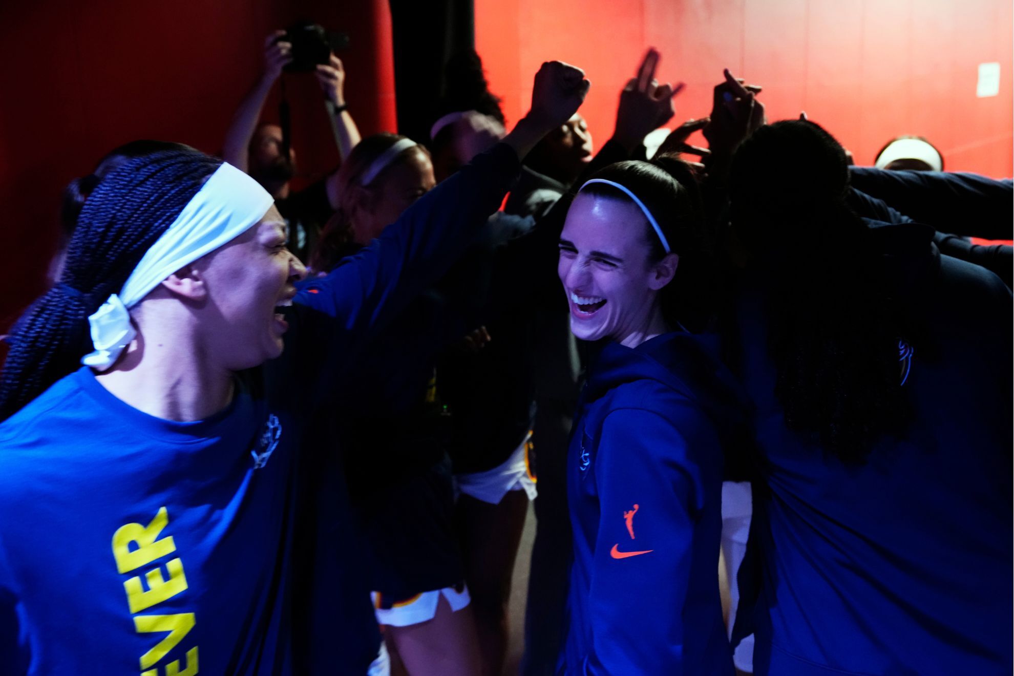 Indiana Fever's Caitlin Clark, right, cheers with teammates before a WNBA basketball game