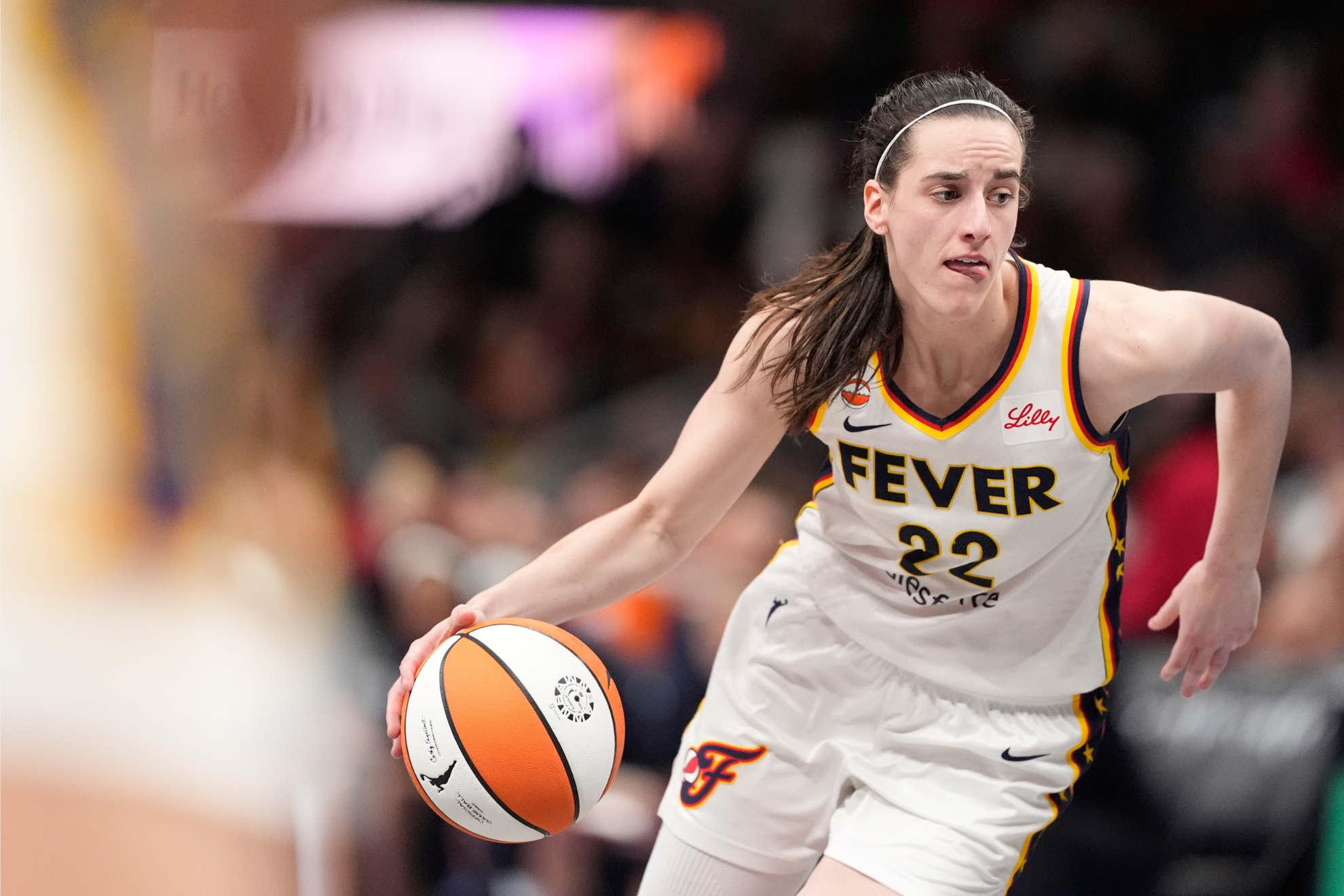 Indiana Fever guard Caitlin Clark (22) dribbles the ball in the second half of an WNBA basketball game