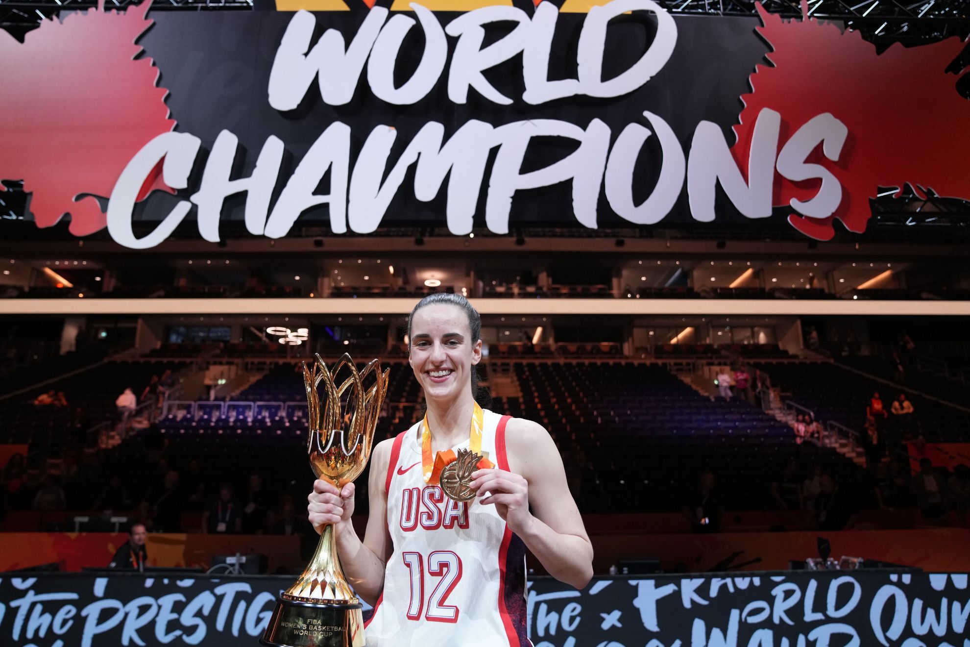 Caitlin Clark of the United States, poses with the trophy after the Women's Basketball World Cup final match