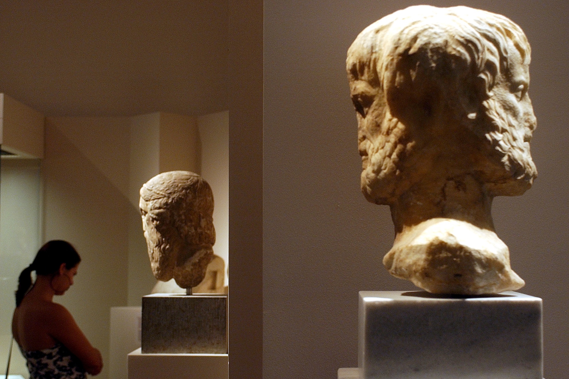A visitor admires a marble bust of ancient Greek philosopher Aristotle LaPresse