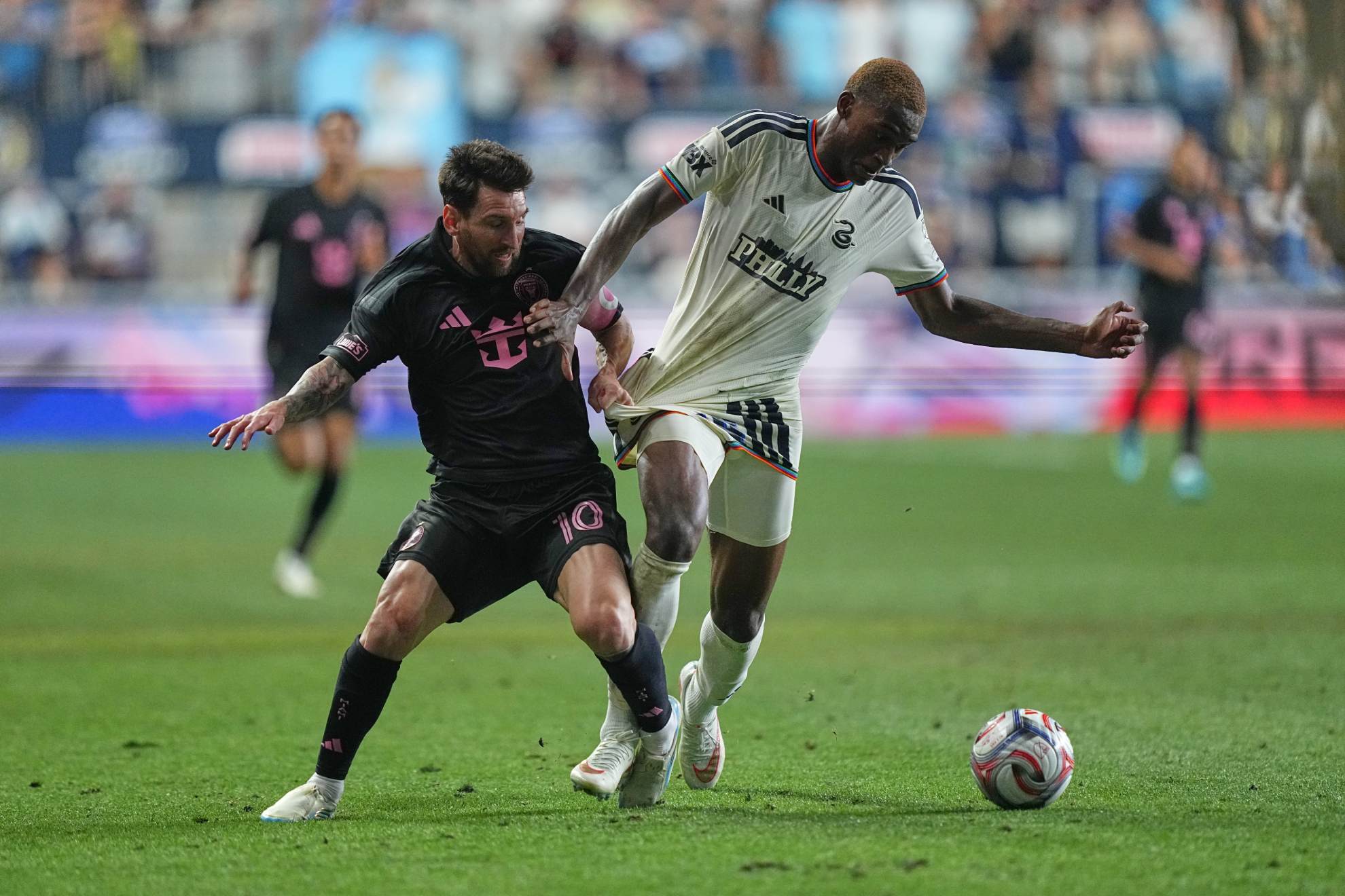 Inter Miami's Leo Messi (10) and Philadelphia Union's Neil Pierre compete for the ball during the second half of an MLS soccer match Matt Rourke
