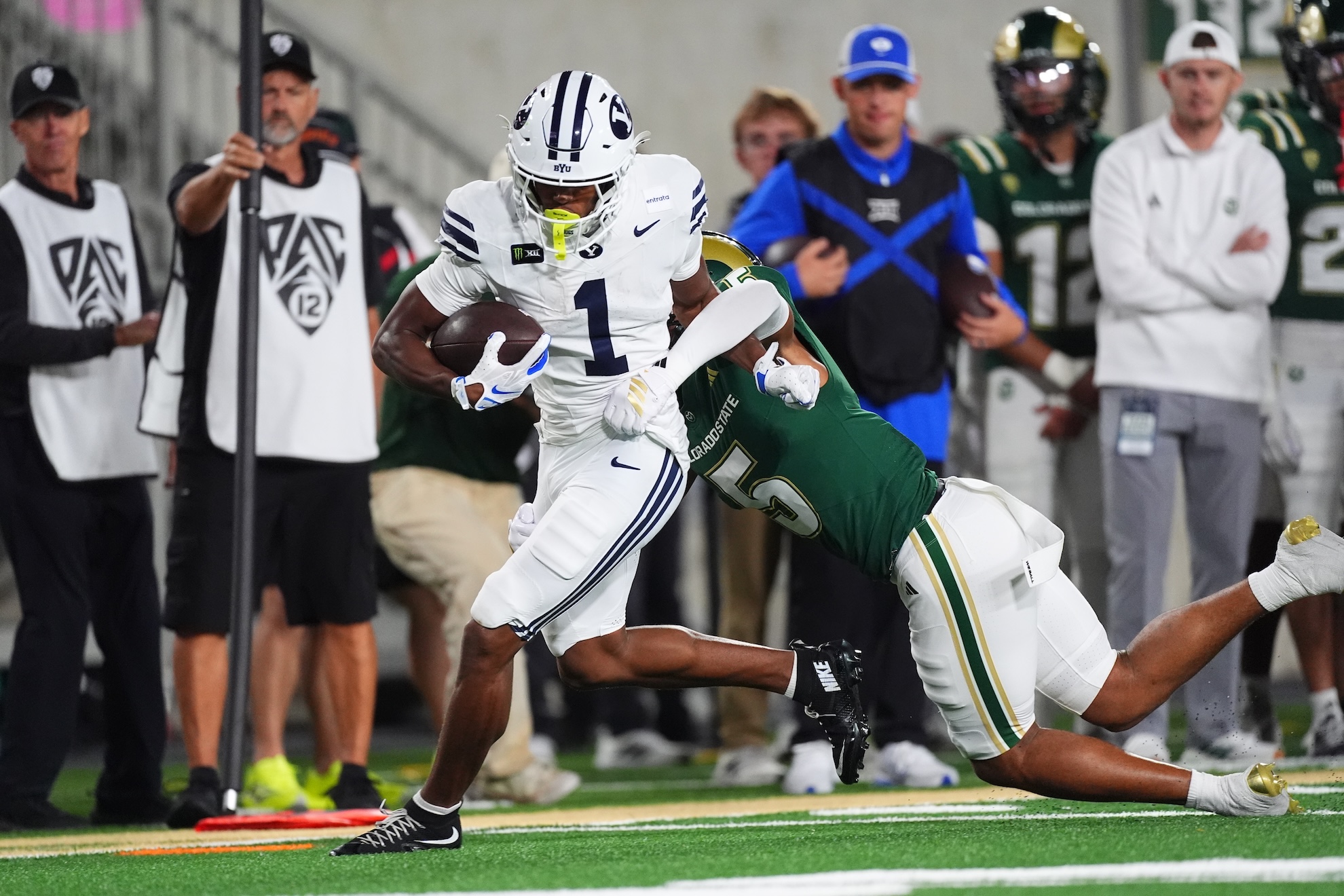 BYU wide receiver Legend Glasker, left, is pulled down by Colorado State defensive back D'Angelo Hagans LaPresse