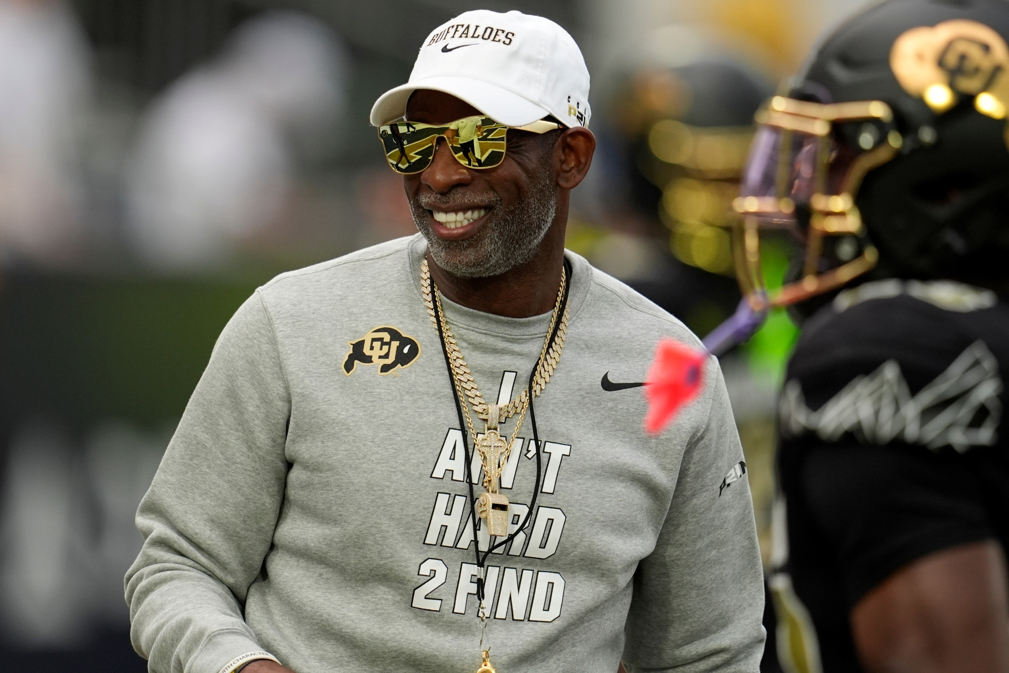 Colorado head coach Deion Sanders walks on the field before an NCAA college football game