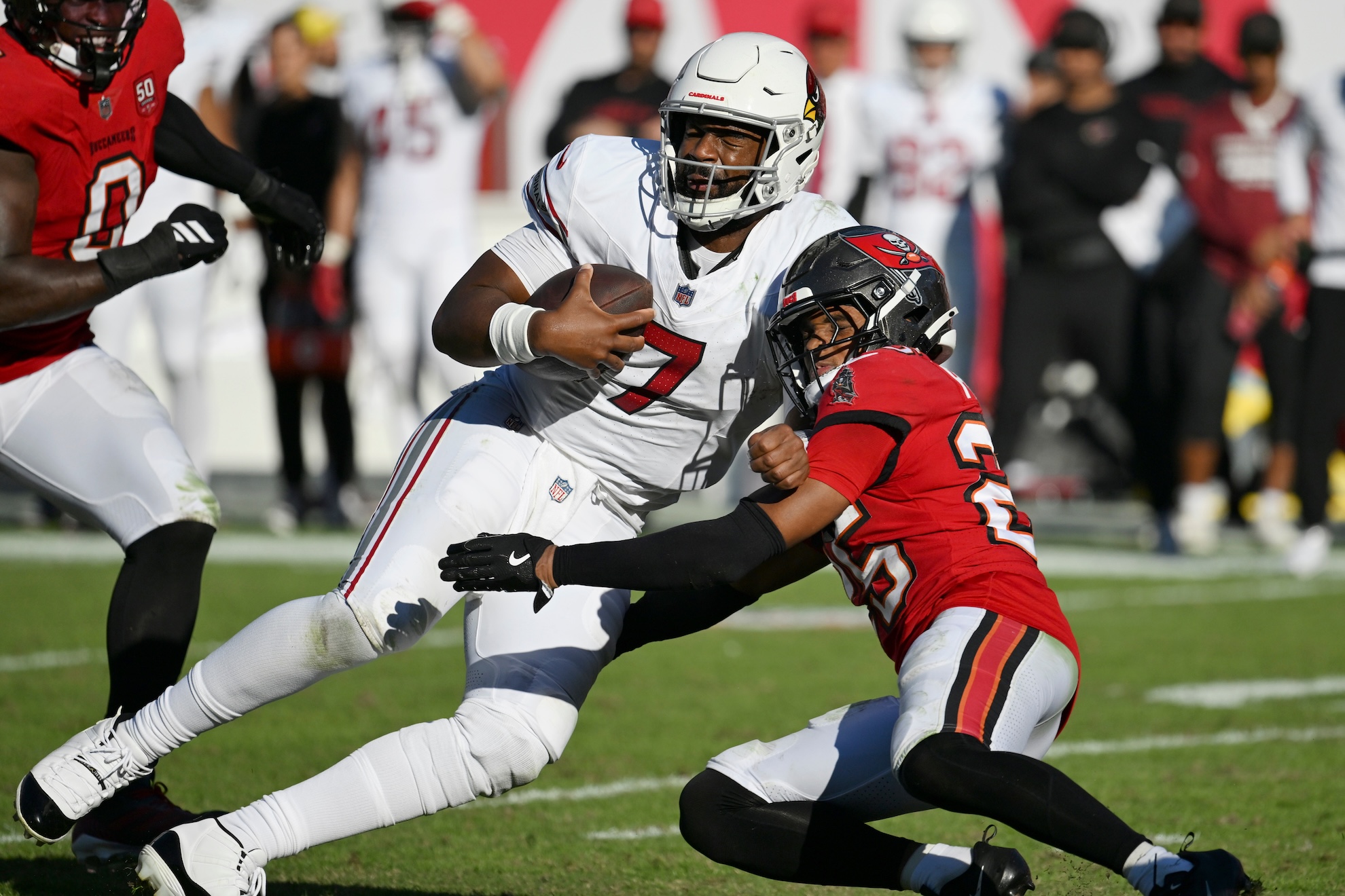 Arizona Cardinals quarterback Jacoby Brissett, left, is tackled by Tampa Bay Buccaneers cornerback Jacob Parrish LaPresse