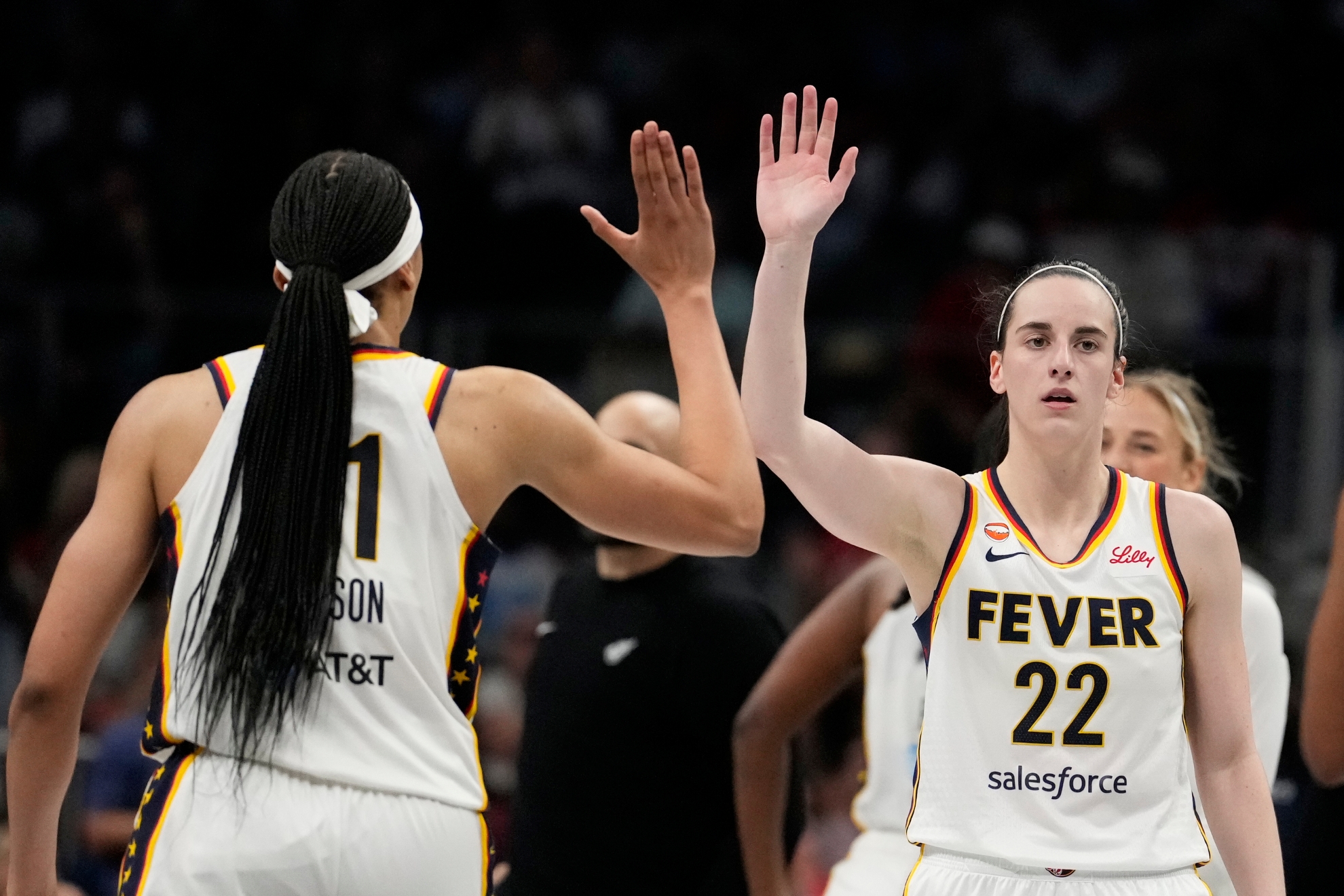Indiana Fever guard Caitlin Clark (22) high-fives teammates during an WNBA basketball game against the Atlanta Dream