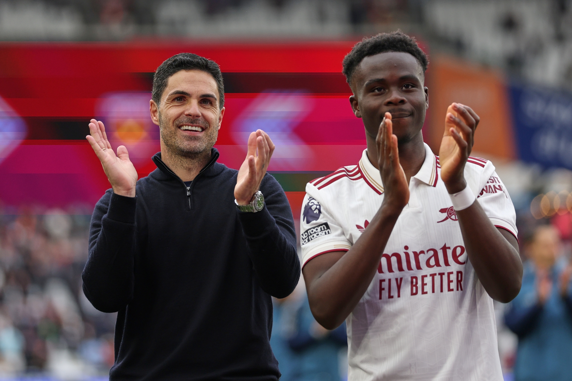 Arsenal's manager Mikel Arteta and Bukayo Saka reacts after the Premier League soccer match between West Ham and Arsenal