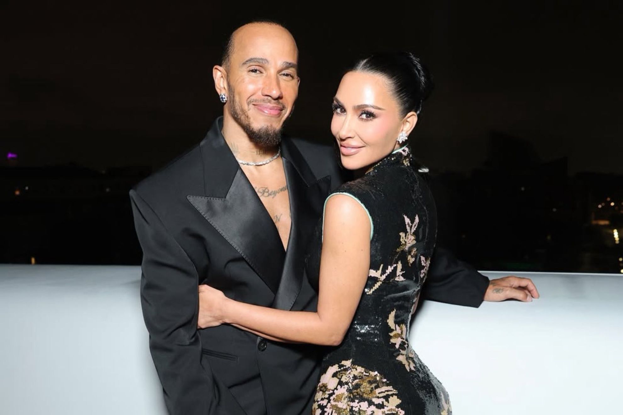 Lewis Hamilton embraces Kim Kardashian as they both smile